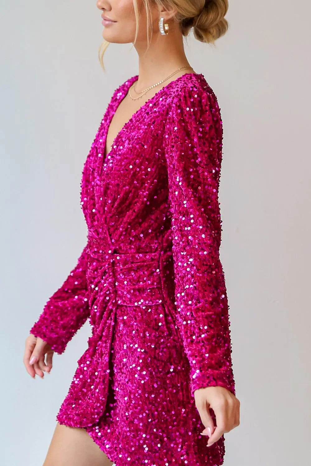Sequin surplice mini dress angled view showing wrap front