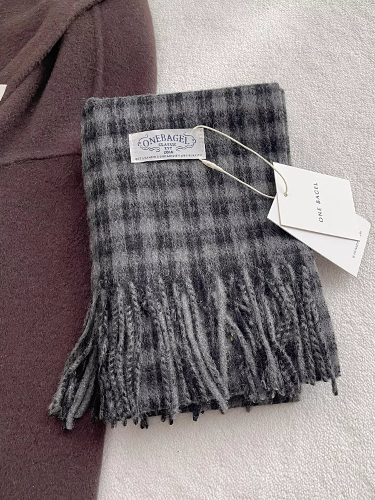 Plaid scarf styled over a winter coat