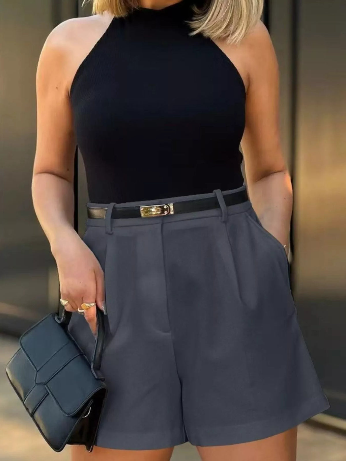 Pleated shorts shown in the dark gray colorway