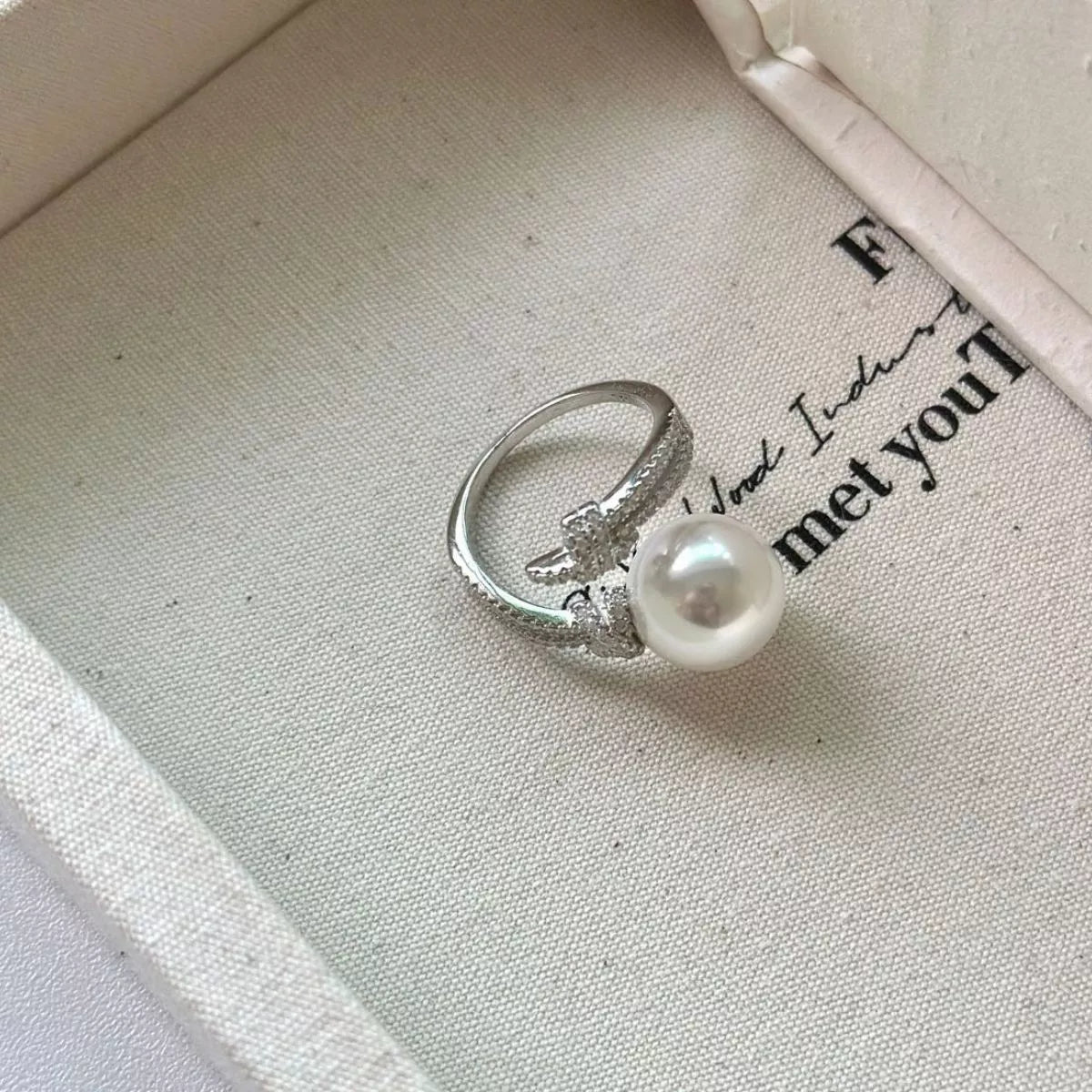 pearl and zircon bypass ring in sterling silver texture detail