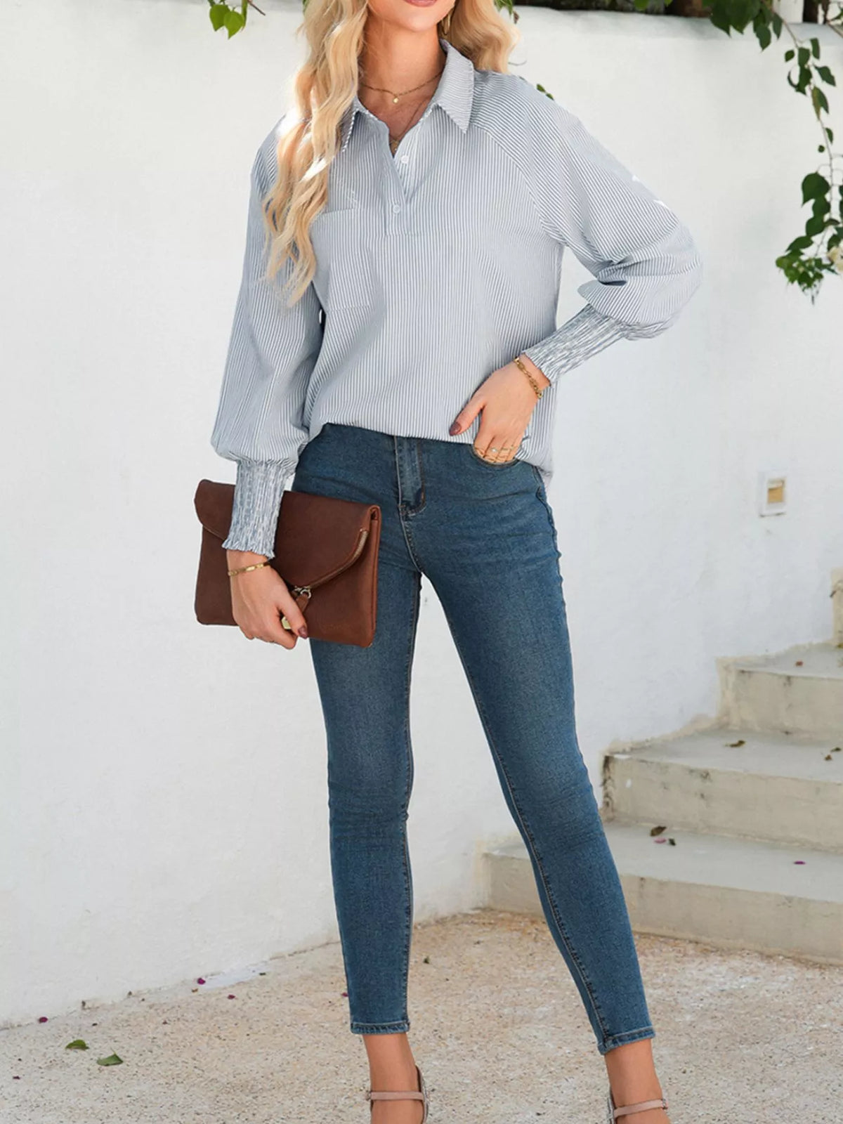 Button placket detail on the pinstripe blouse