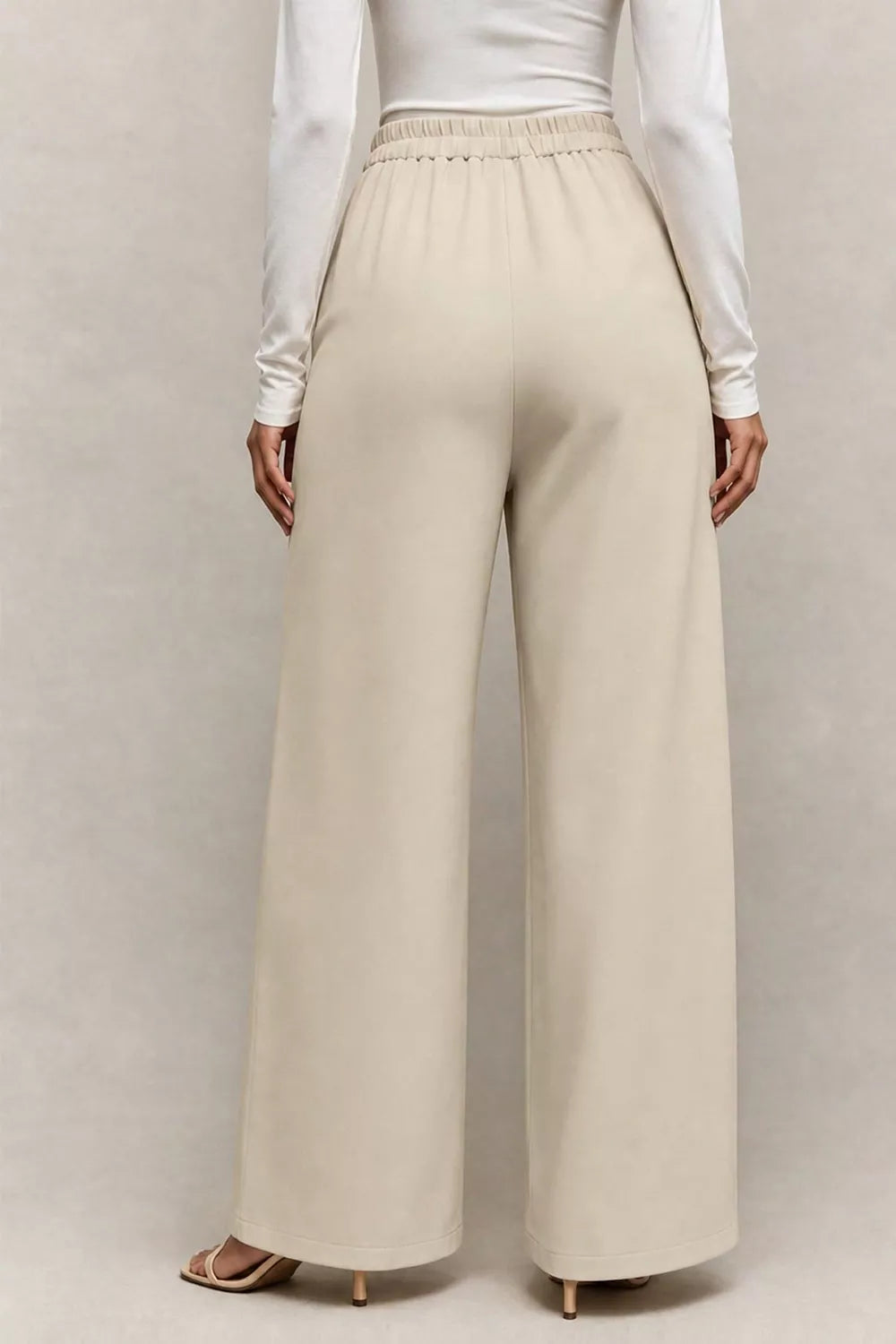 Side view of the asymmetrical wide leg pants showing the long leg