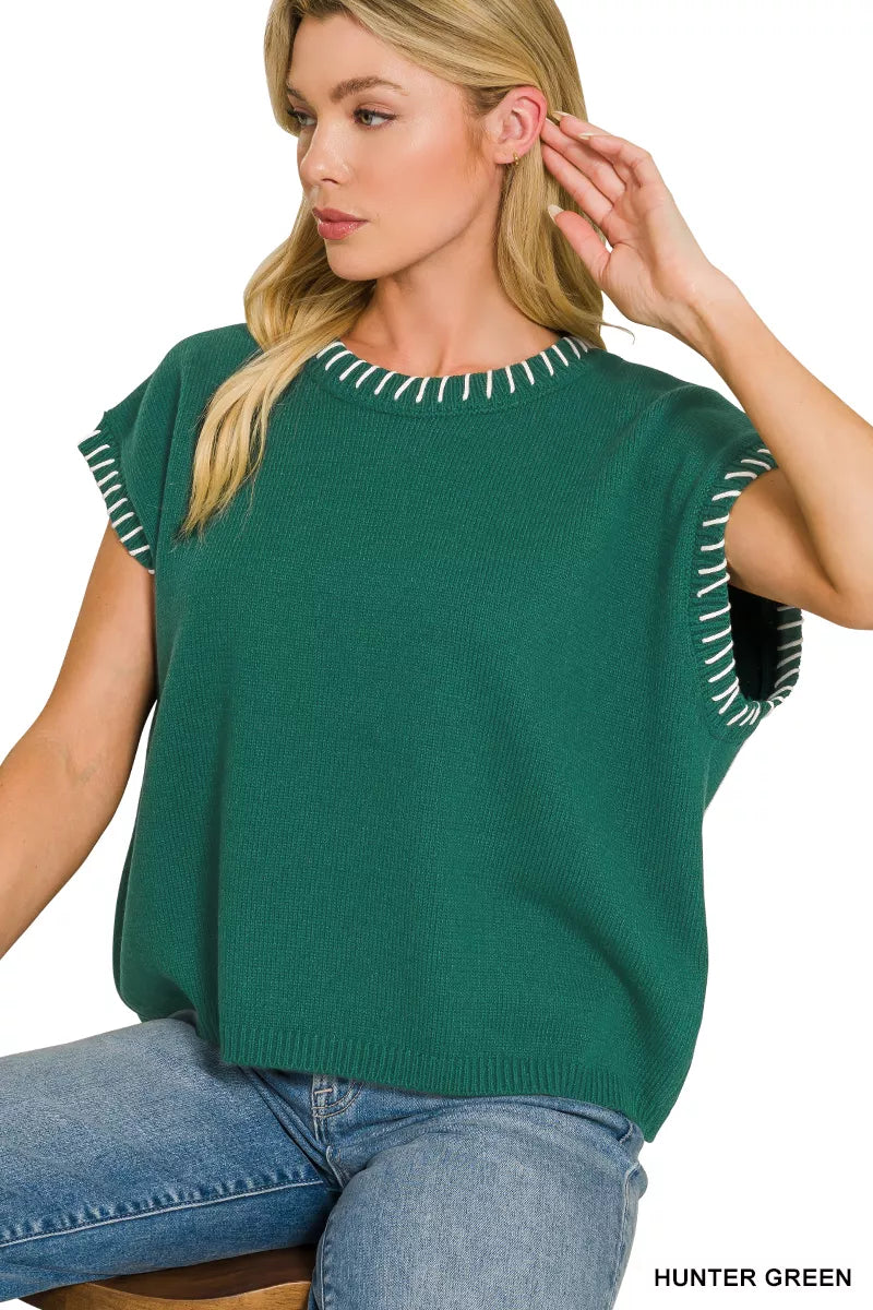 Stitch detailing on green cozy sweater