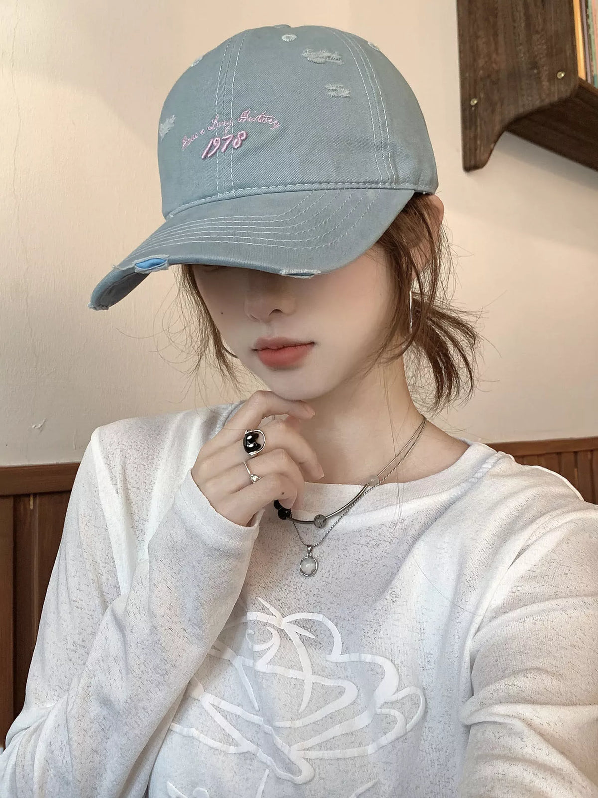 Light blue embroidered distressed baseball cap detail view