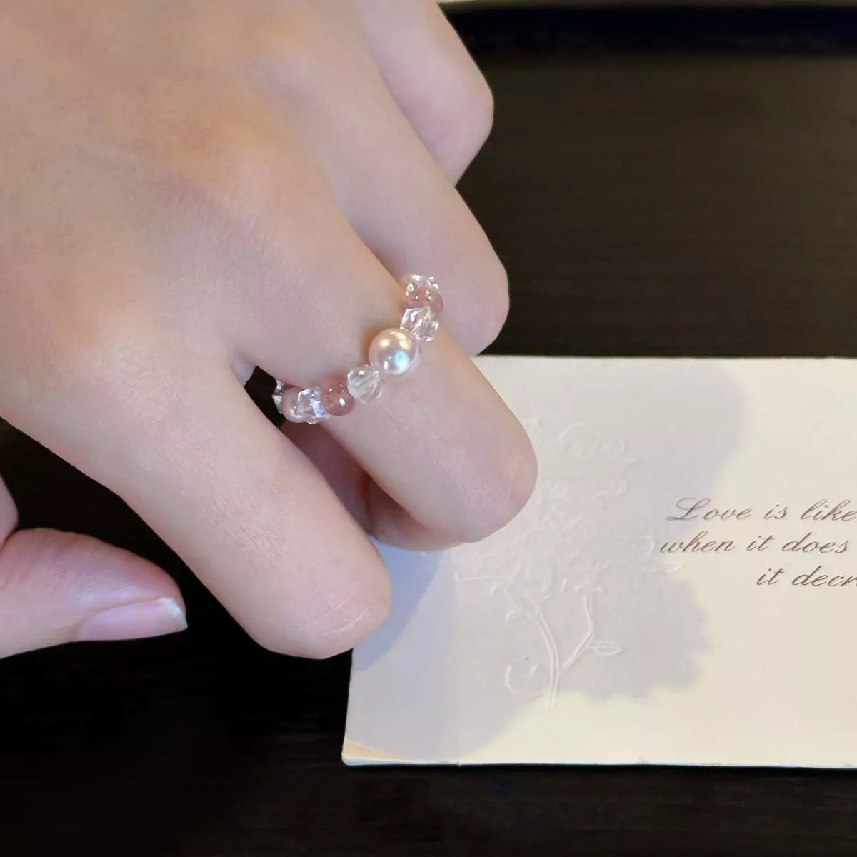 Pearl and crystal bead ring on hand