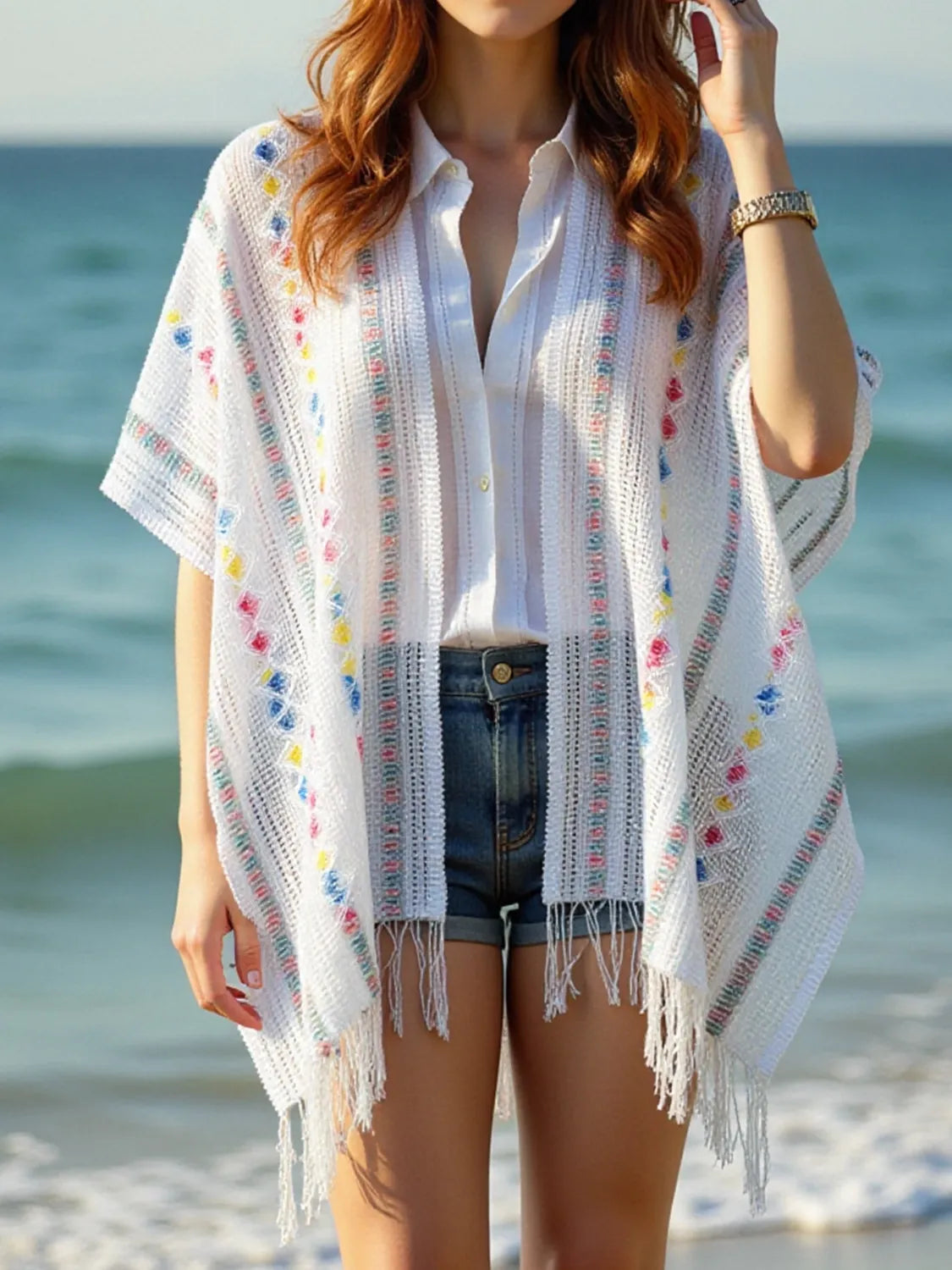 Side view of white draped knit cape