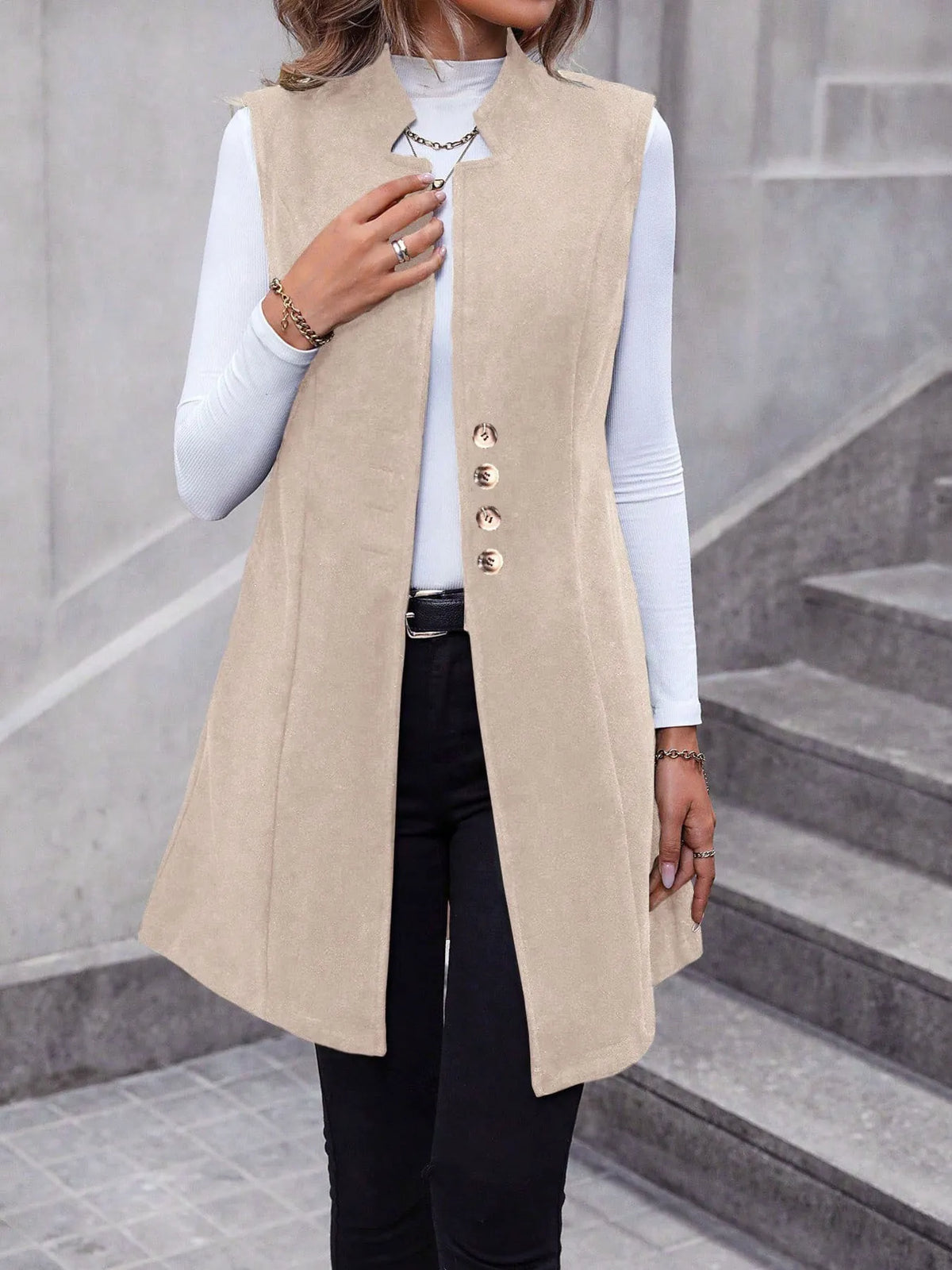 Side view of longline vest layered over a top