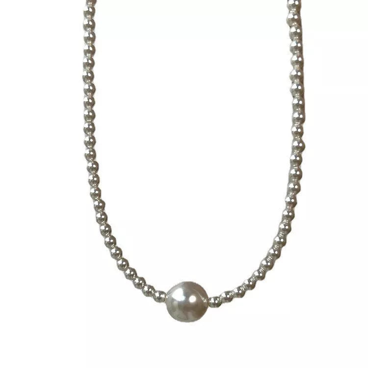 White pearl bead choker necklace, close up fabric detail