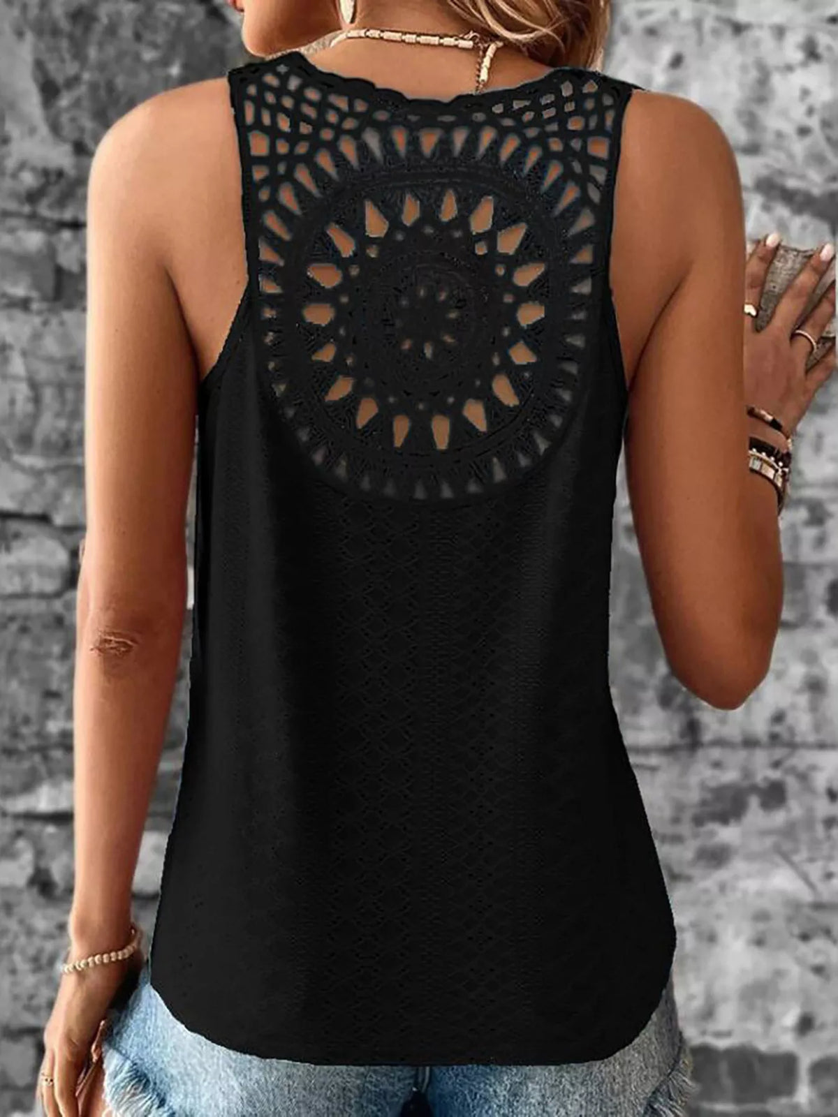Model wearing the eyelet trim tank top with denim