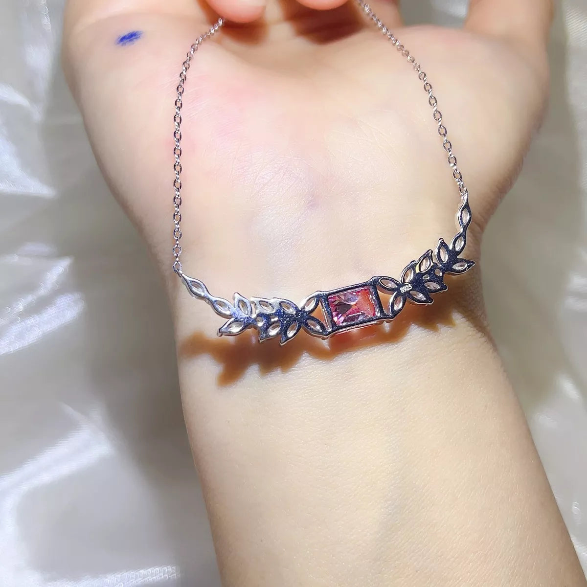 Silver chain detail on pink moissanite necklace