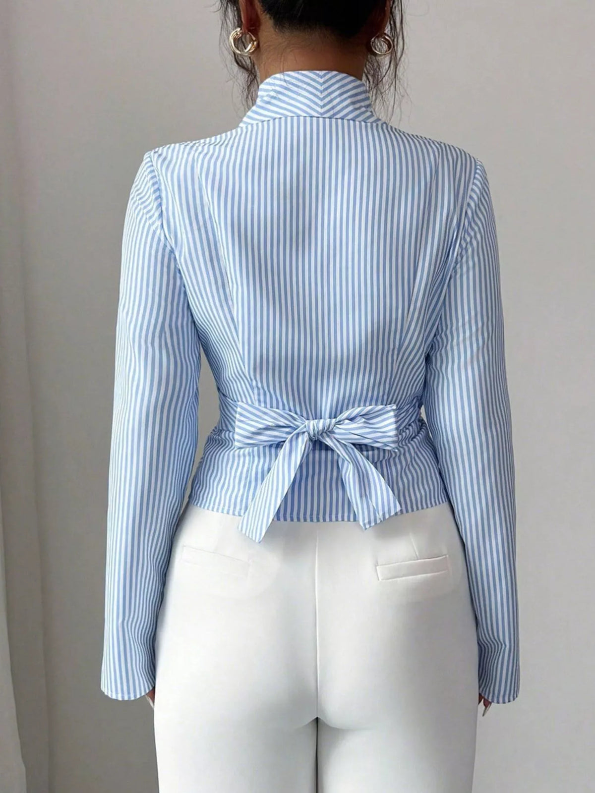 Blue wrap blouse styled with the sleeves worn full length