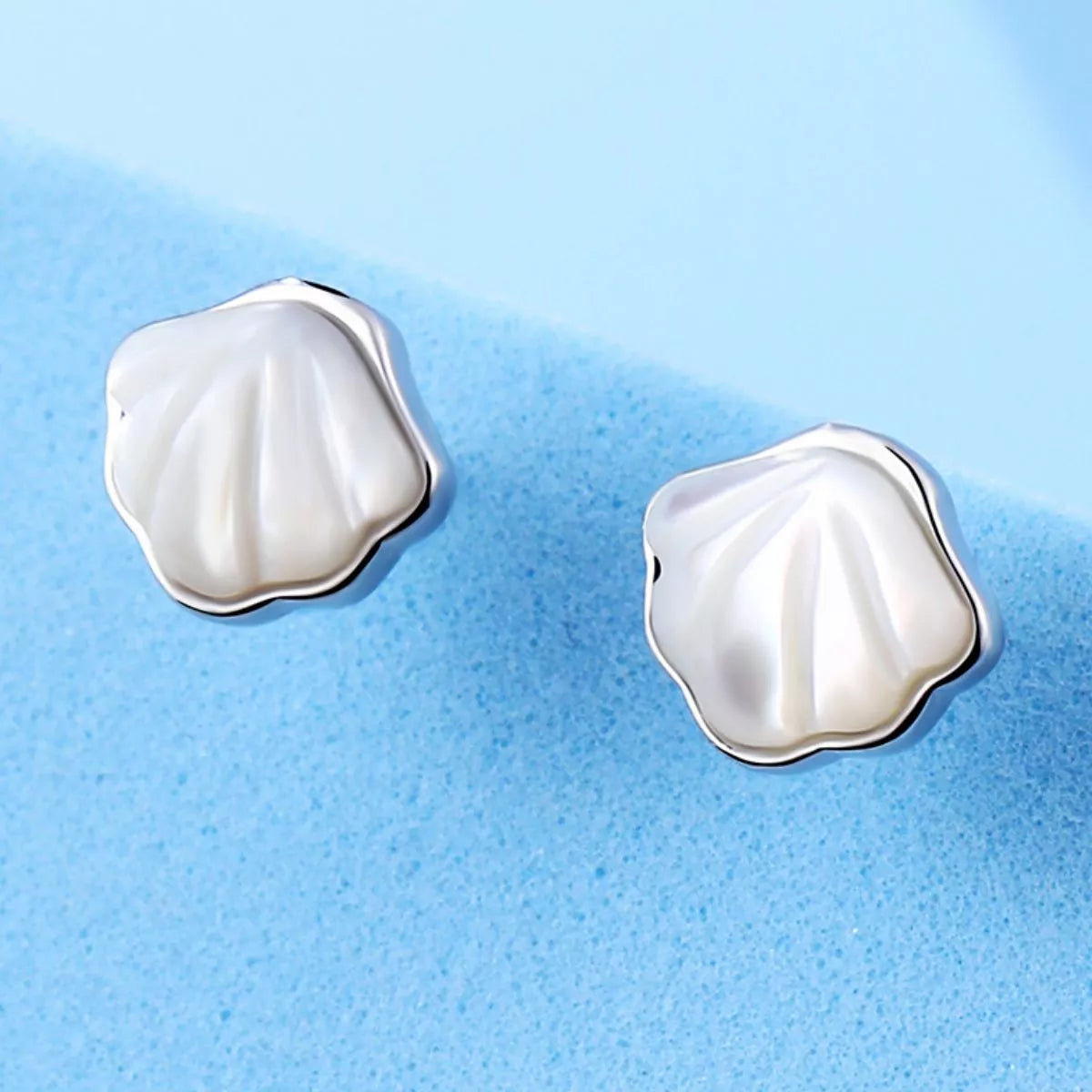Shell stud earring worn on the ear
