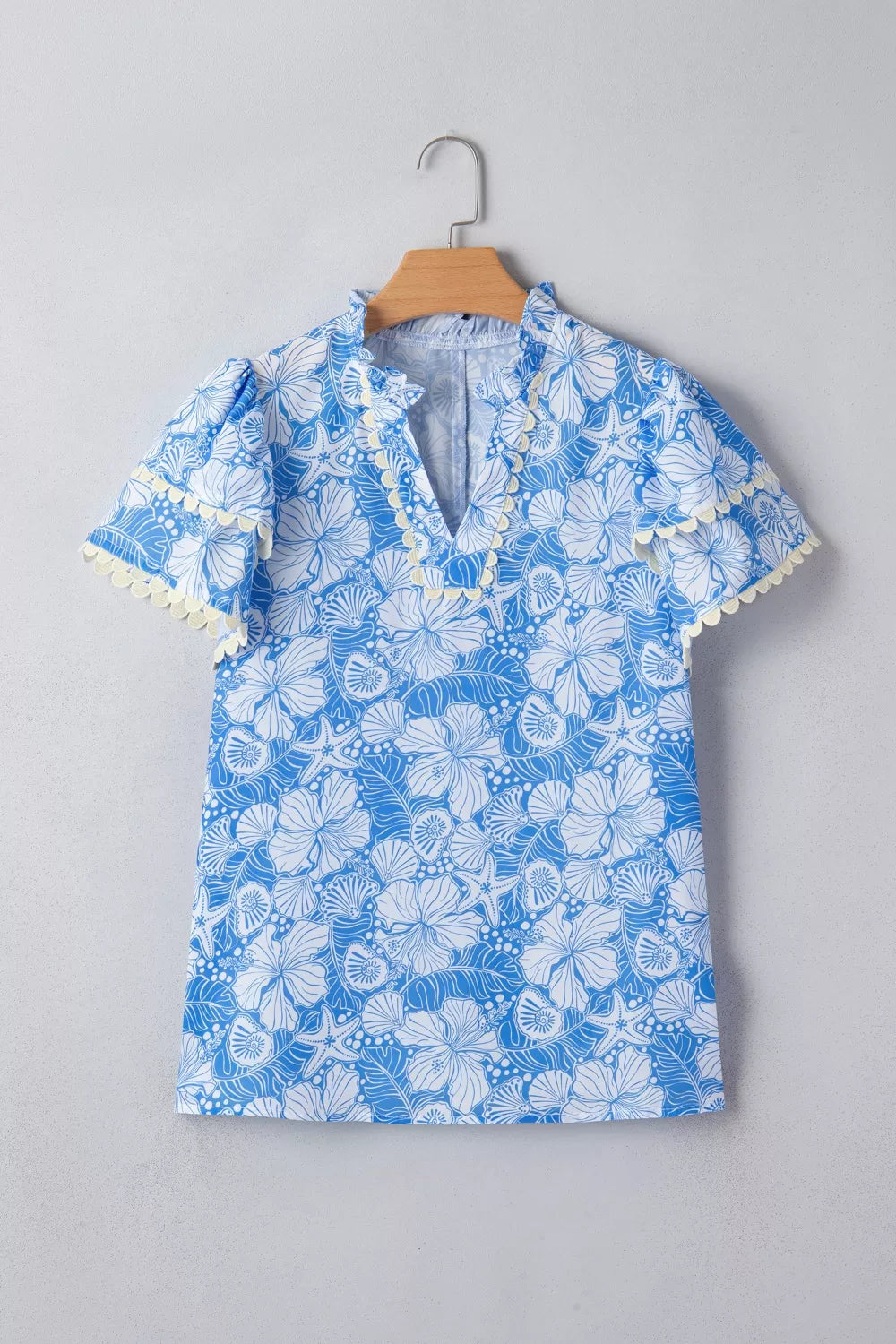 Light blue floral scalloped trim v neck blouse back view
