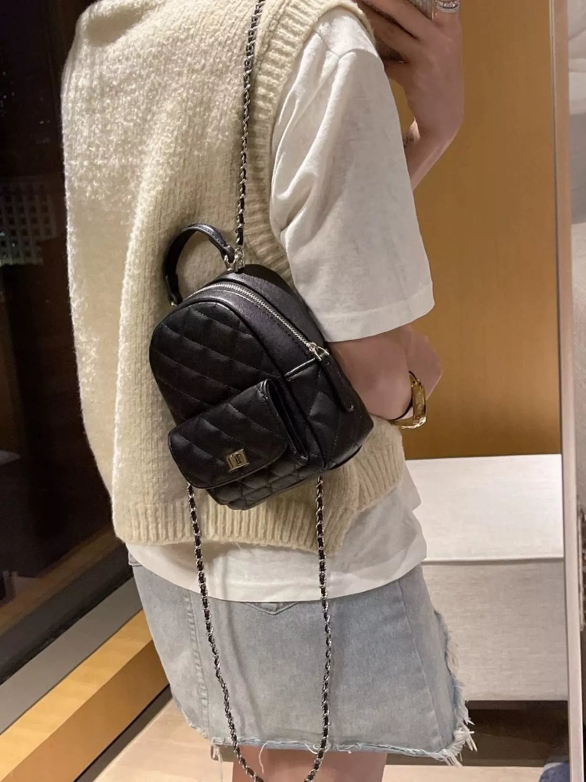 Quilted mini backpack flat lay