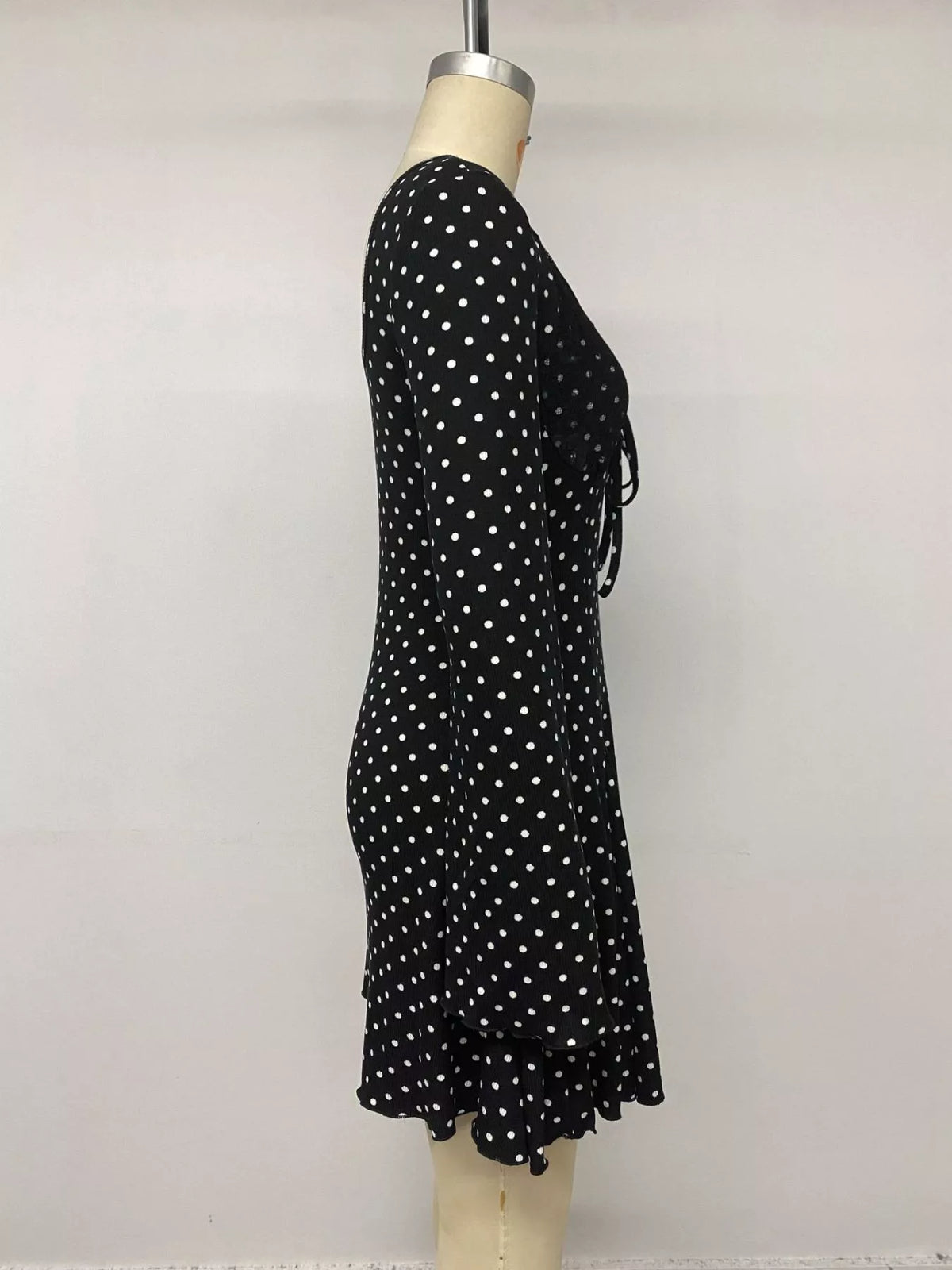 Black polka dot dress styled with boots