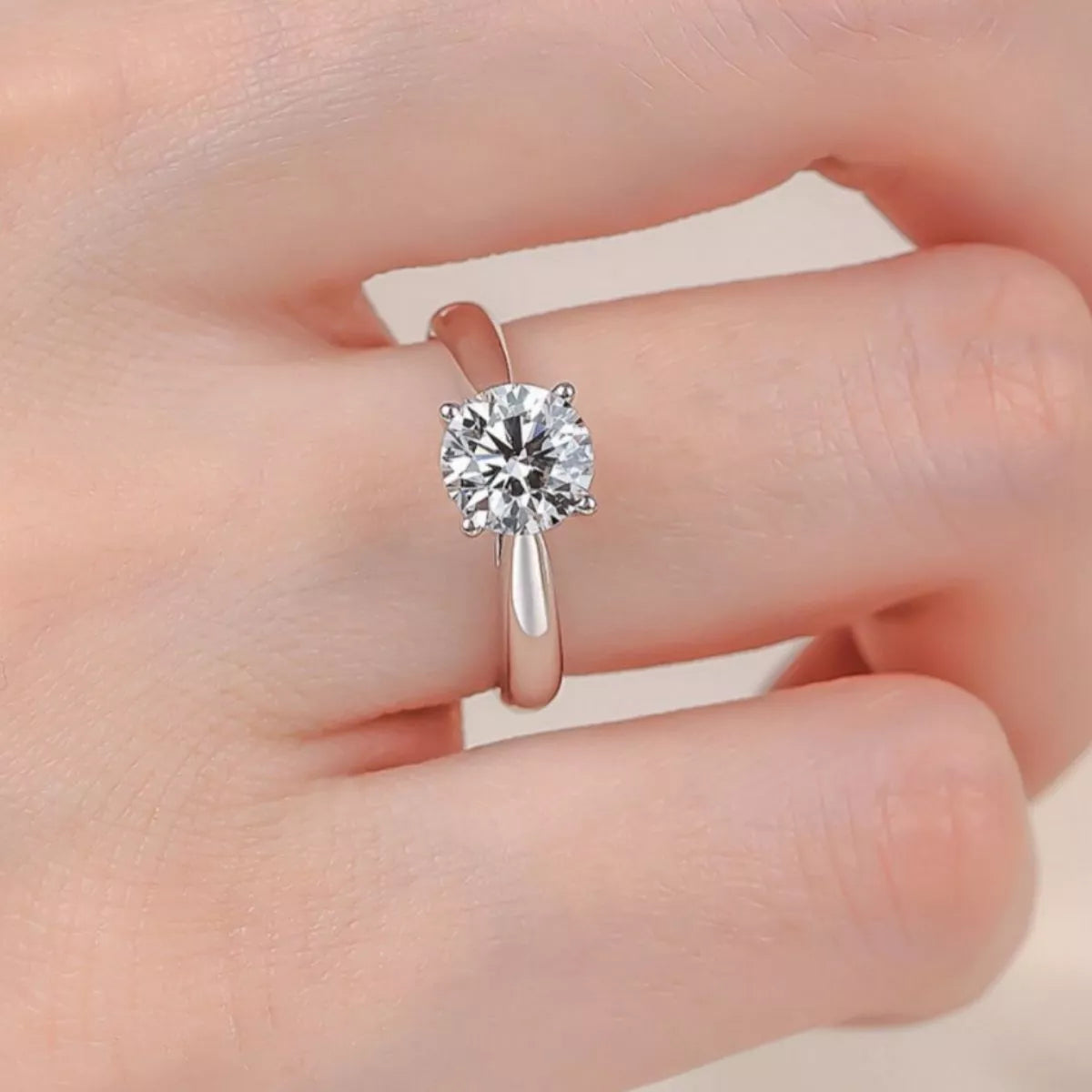Moissanite ring worn on a finger at an angle