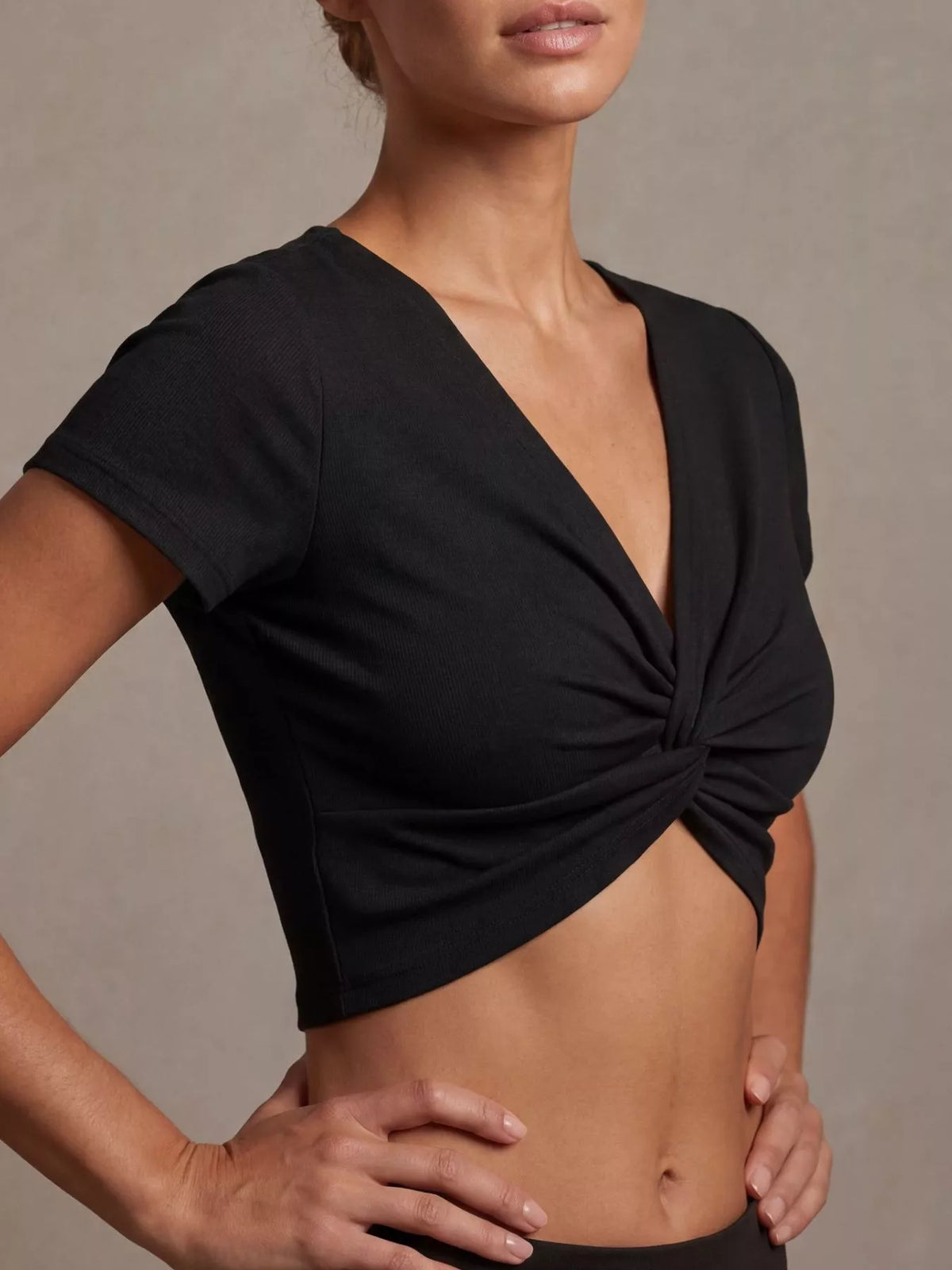 Black twist front cropped top, side view