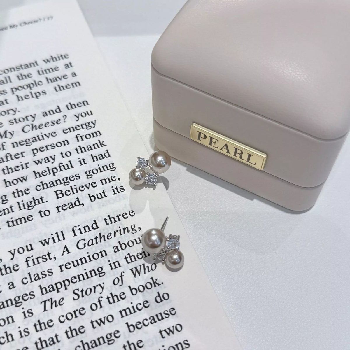 Silver pearl stud earrings on ear