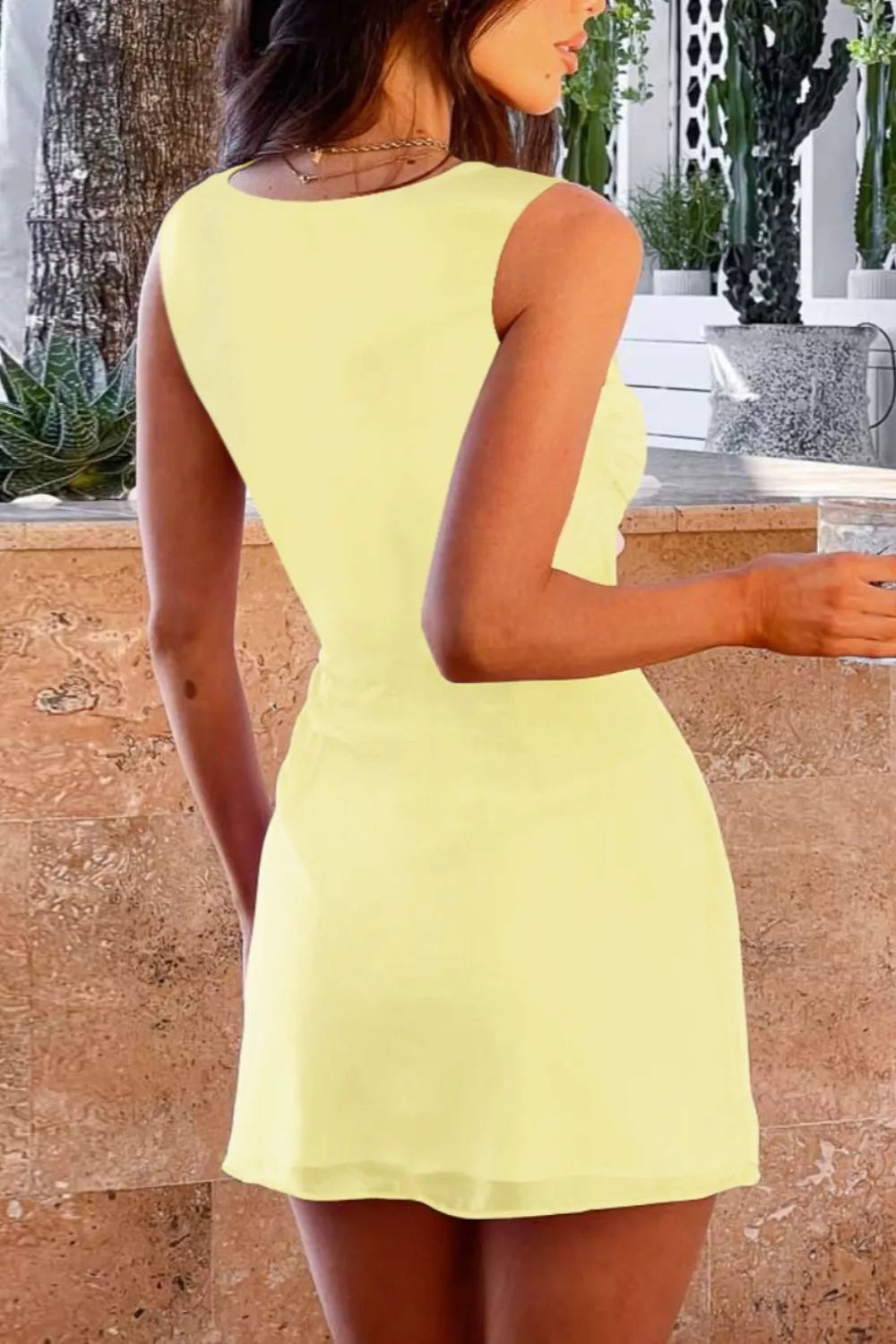 Pastel yellow sleeveless mini dress back view