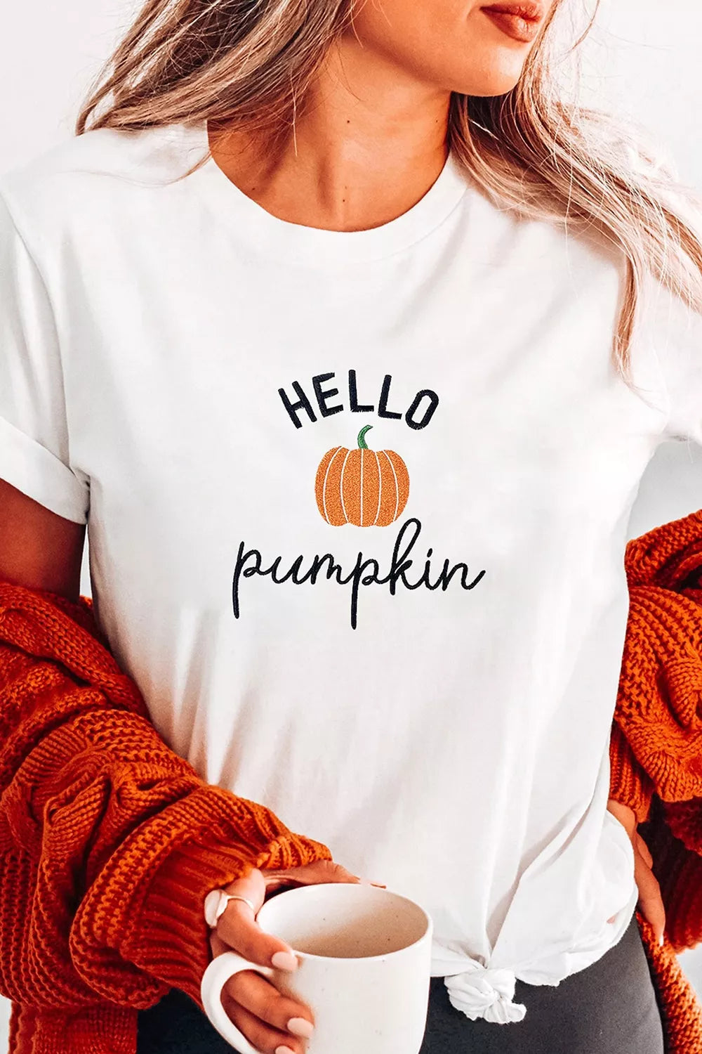 Close up of the pumpkin embroidery stitching on the tee
