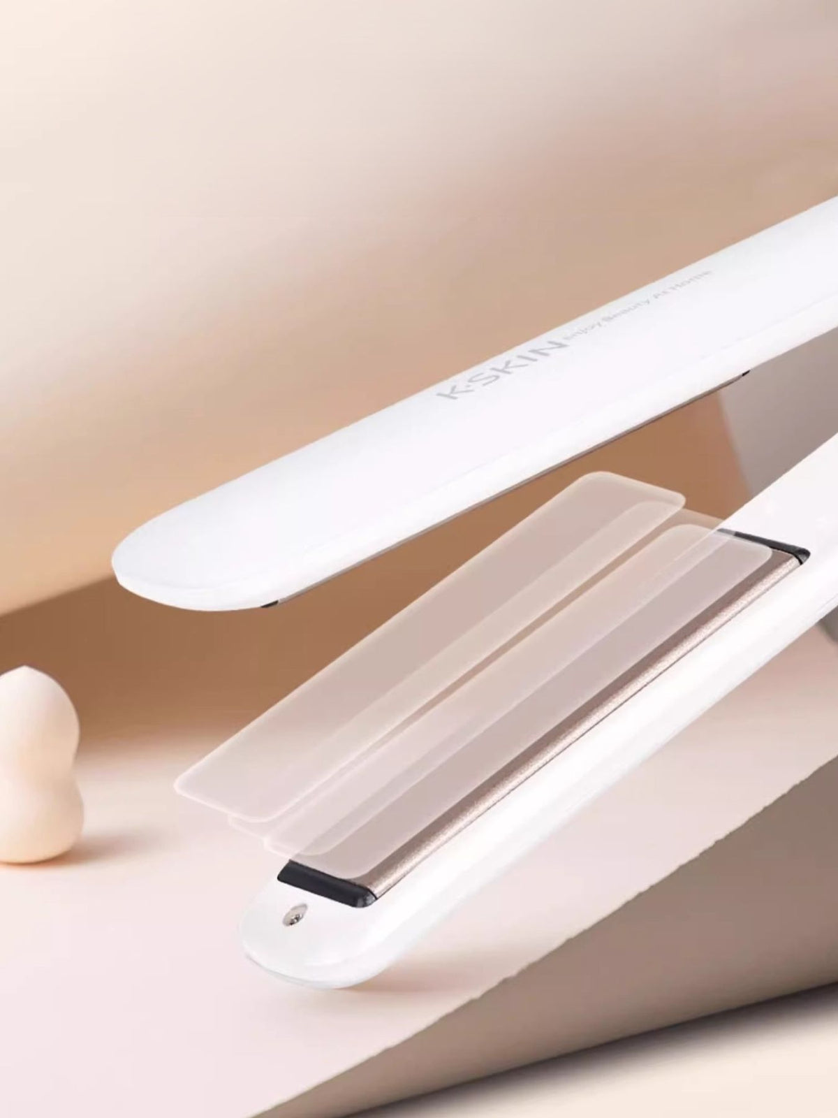 Hair straightener in use on hair