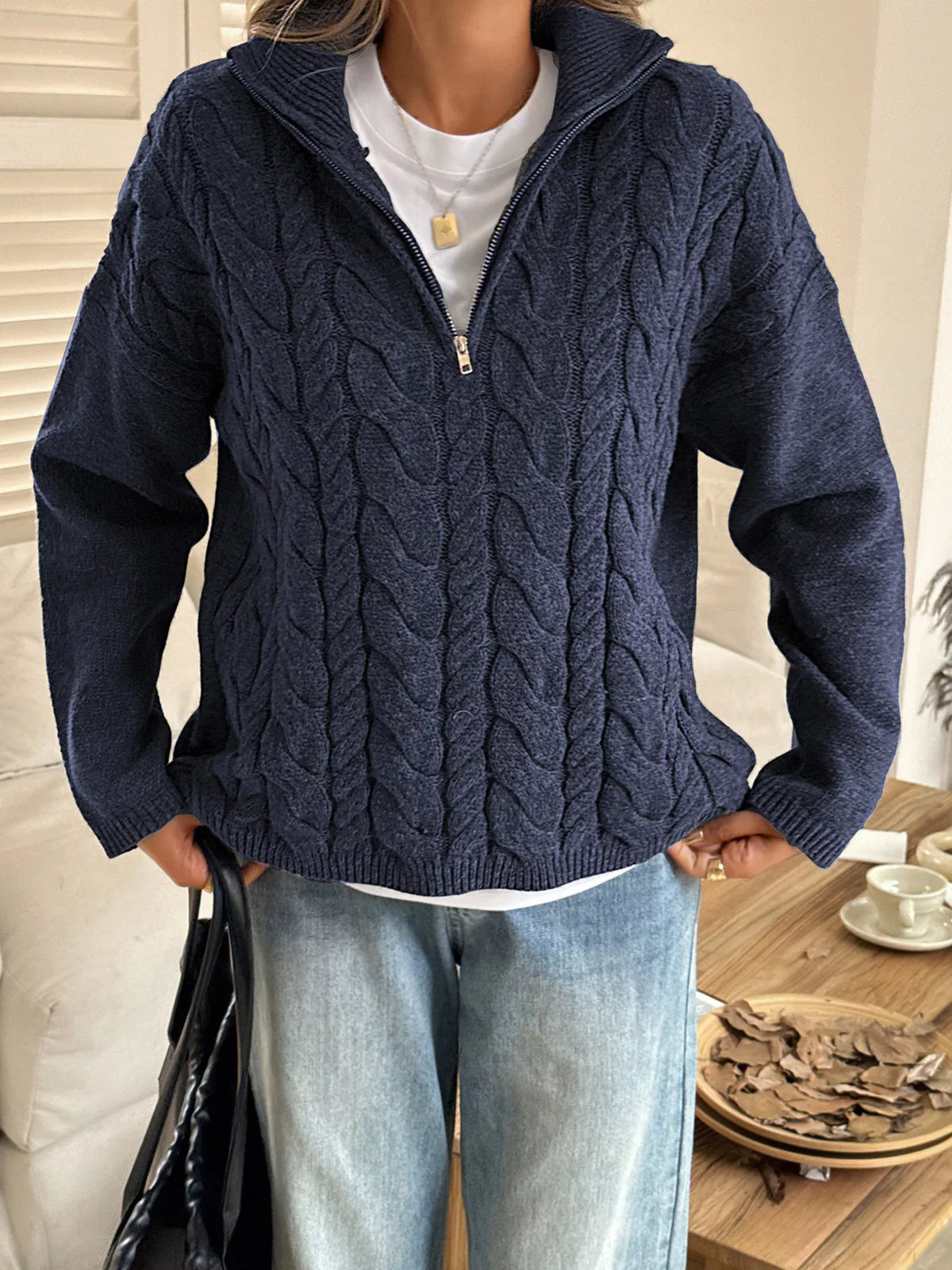 Zip collar cable knit sweater styled with denim