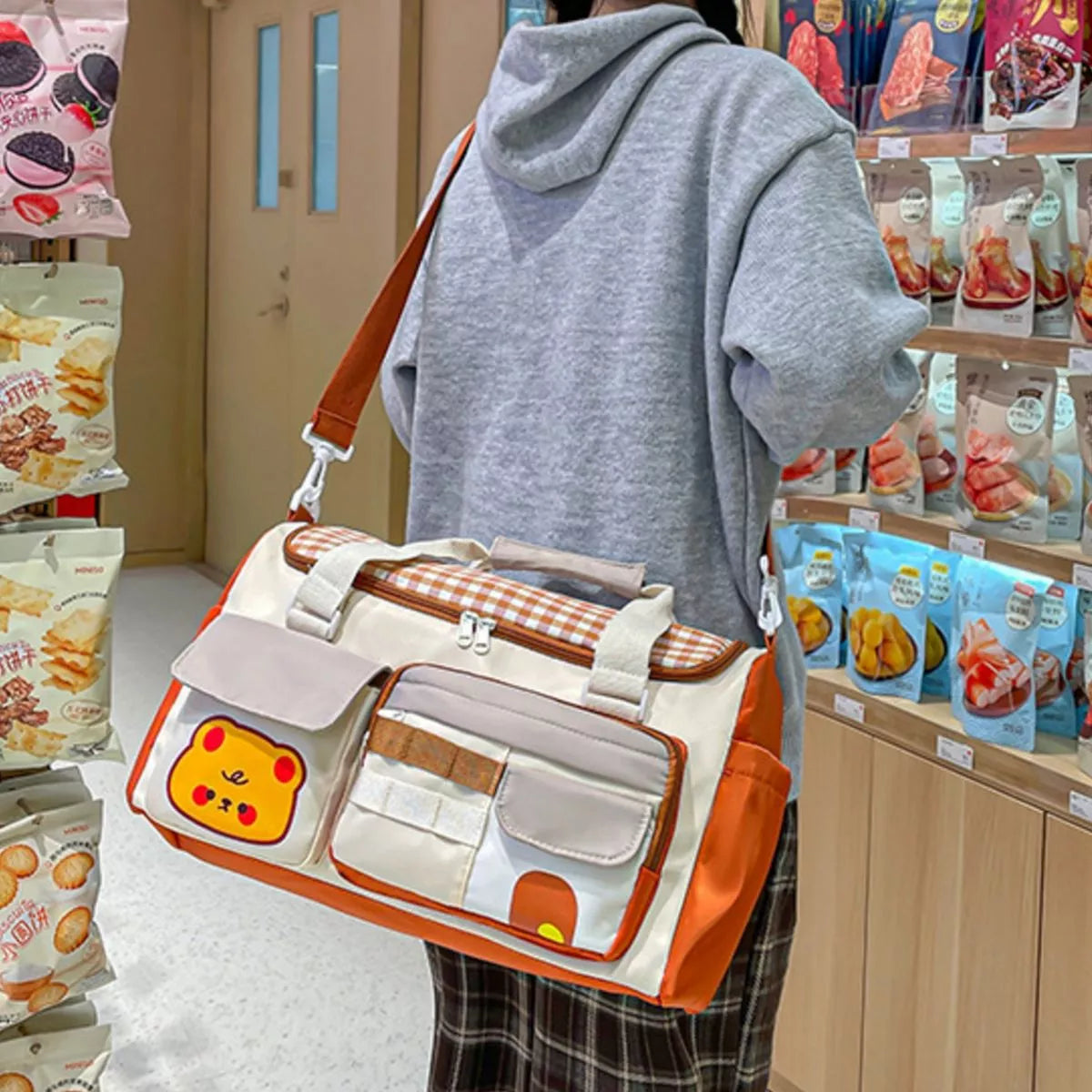 Model carrying cartoon bear travel duffel