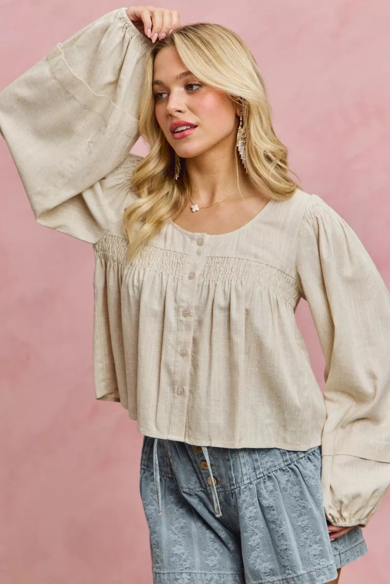 Cream linen blend smocked long sleeve top, on model