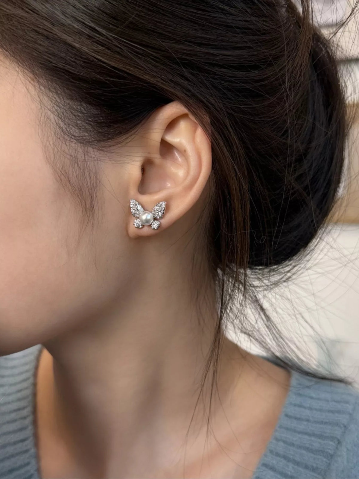 butterfly pearl stud earrings close up detail