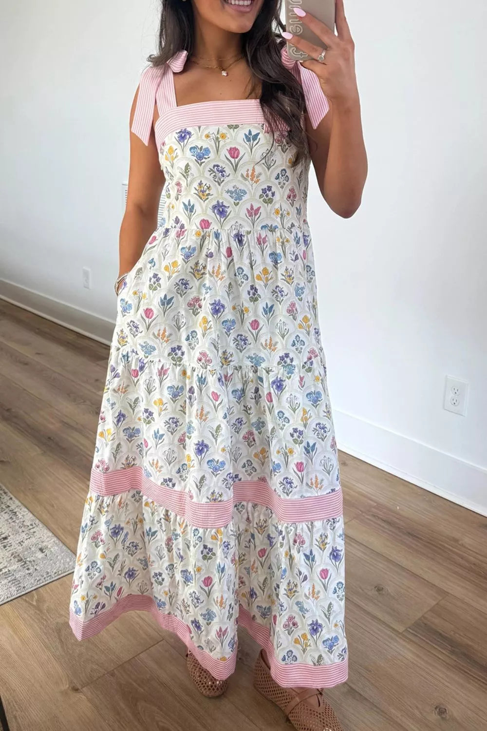 Model wearing white floral tie shoulder dress, full length