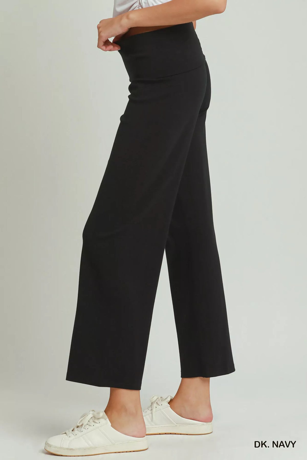 Folded waistband detail on the navy straight leg pants