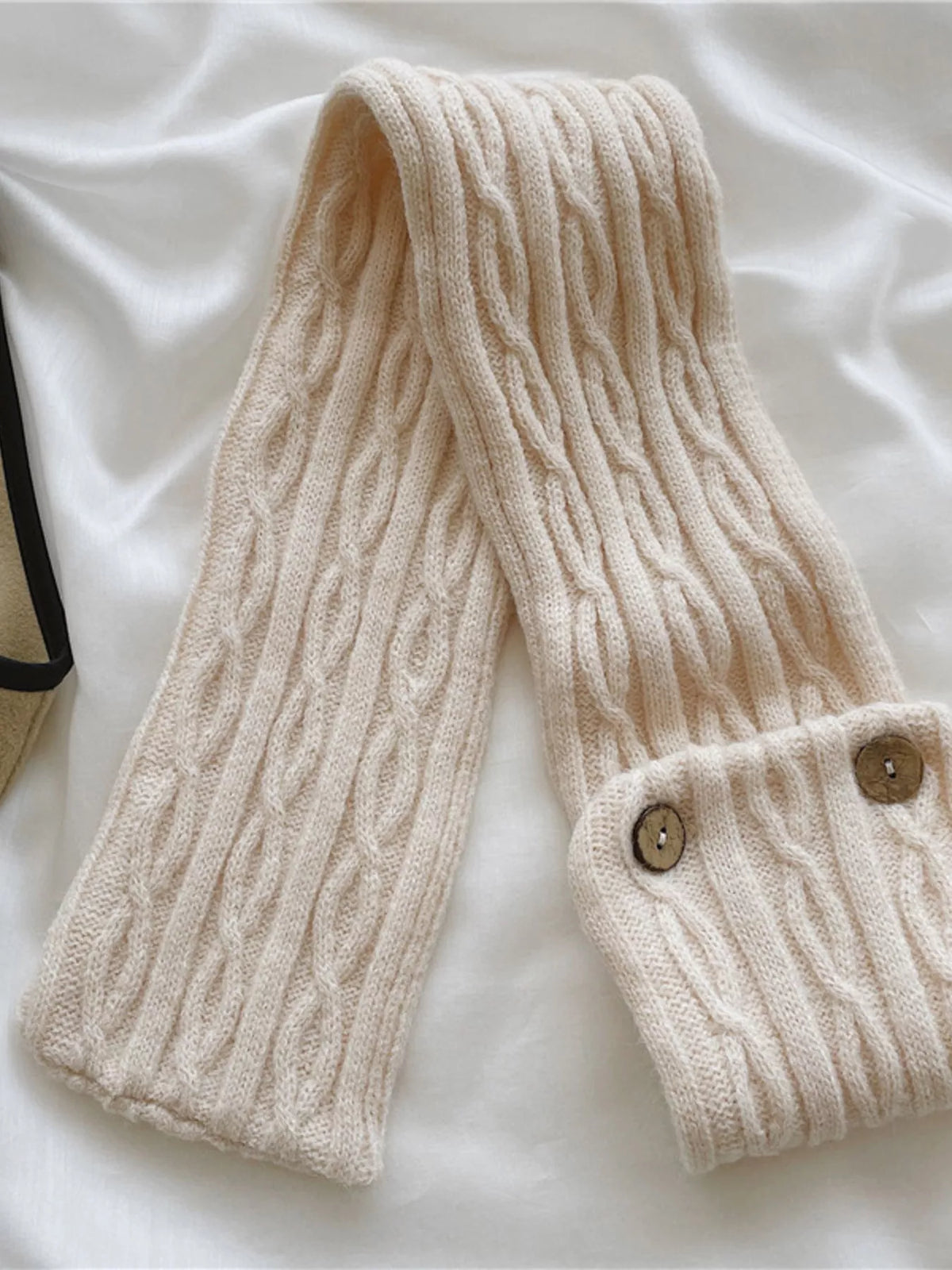 Button accent scarf fastened at the neck