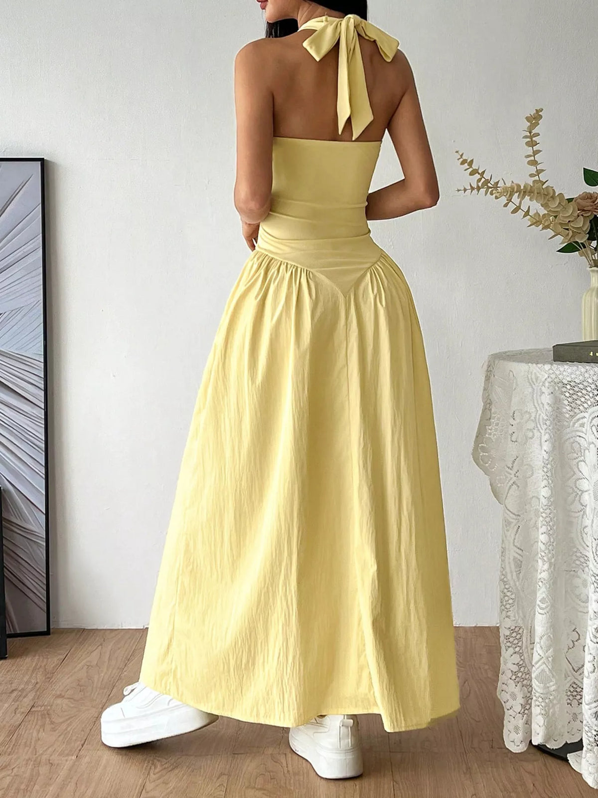 Halter neckline detail on the yellow maxi dress