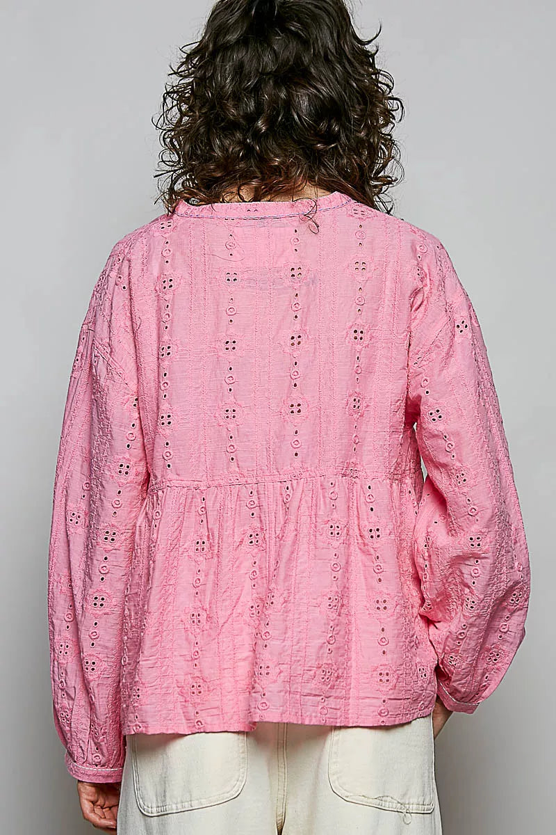 Split neckline with ladder trim on the pink cotton blouse