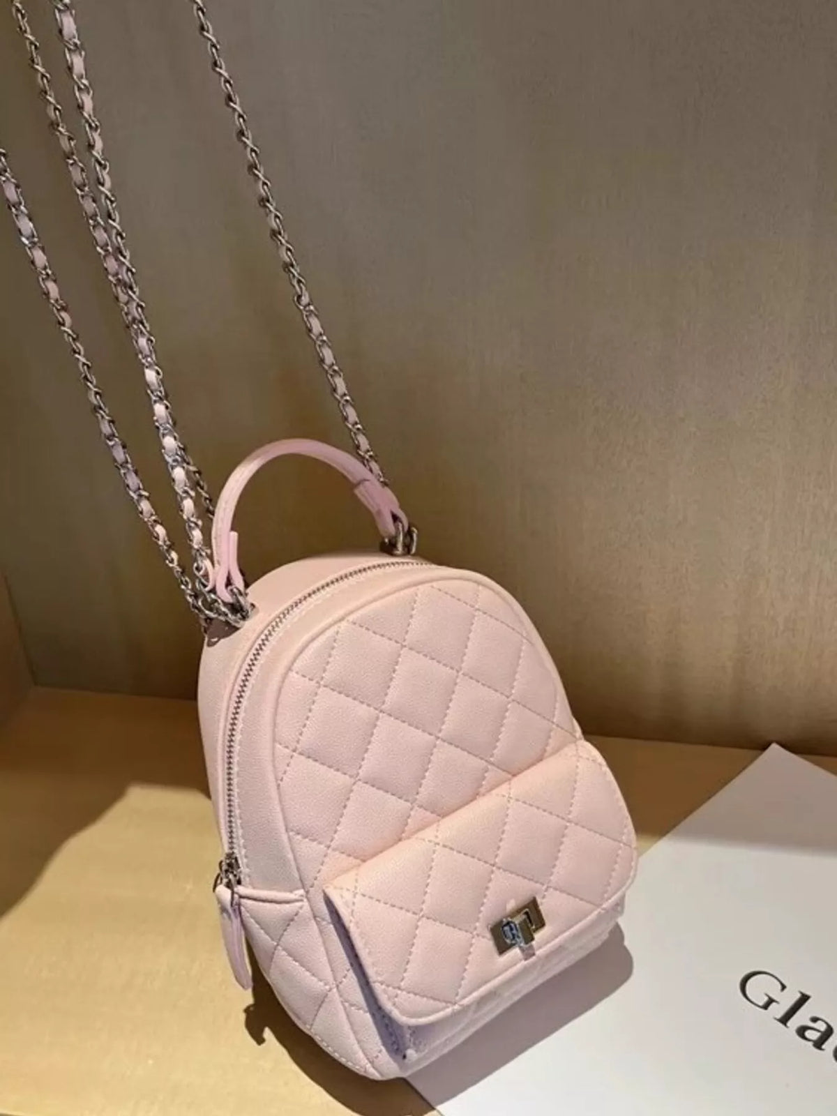 Quilted mini backpack worn on the back