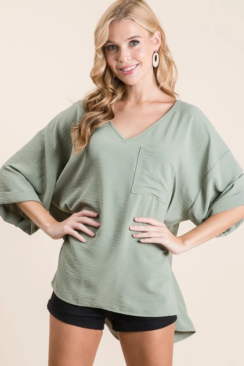 Sage green flowy top side view
