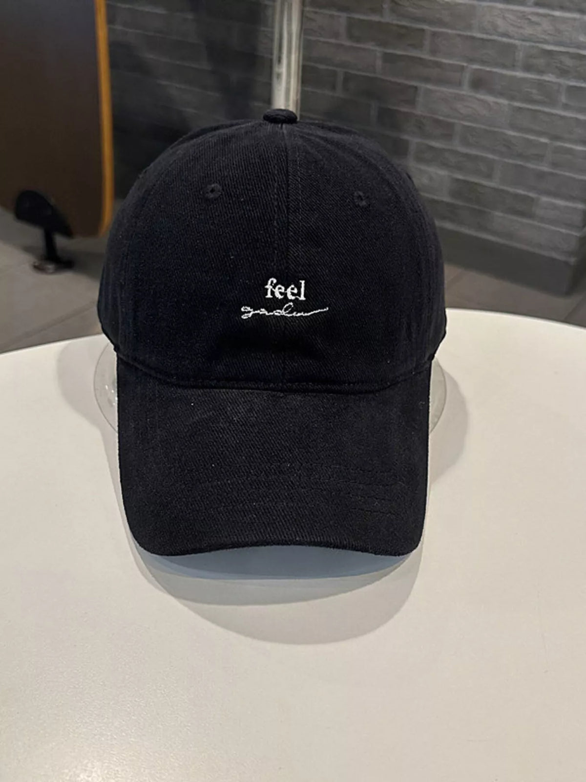 Embroidered cotton cap worn on model