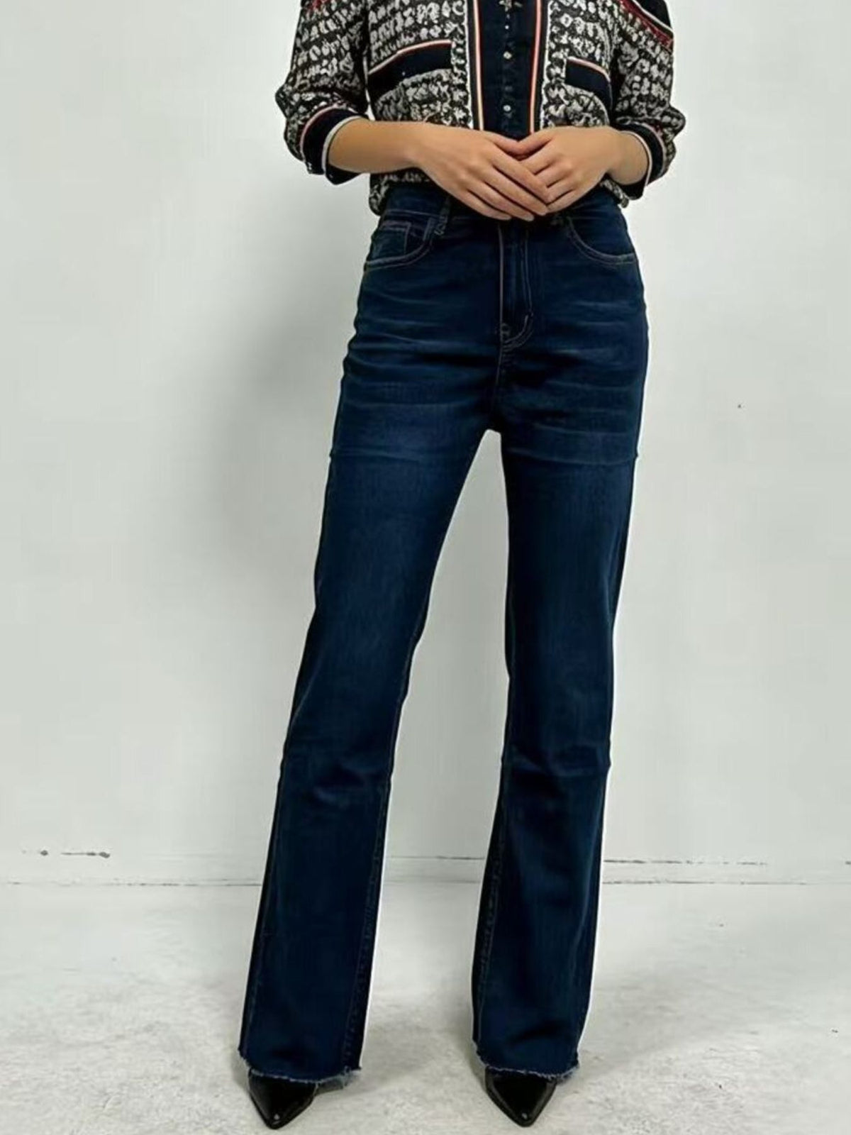 Detail of button closure on bootcut jeans