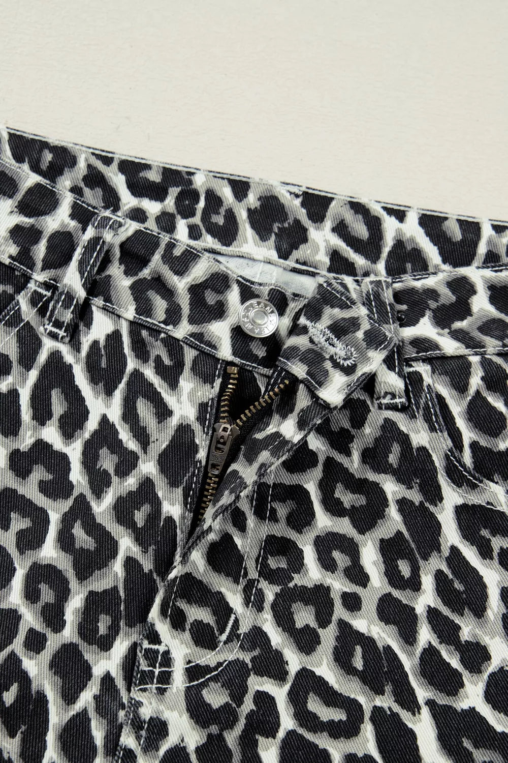 Standing pose in leopard barrel jeans