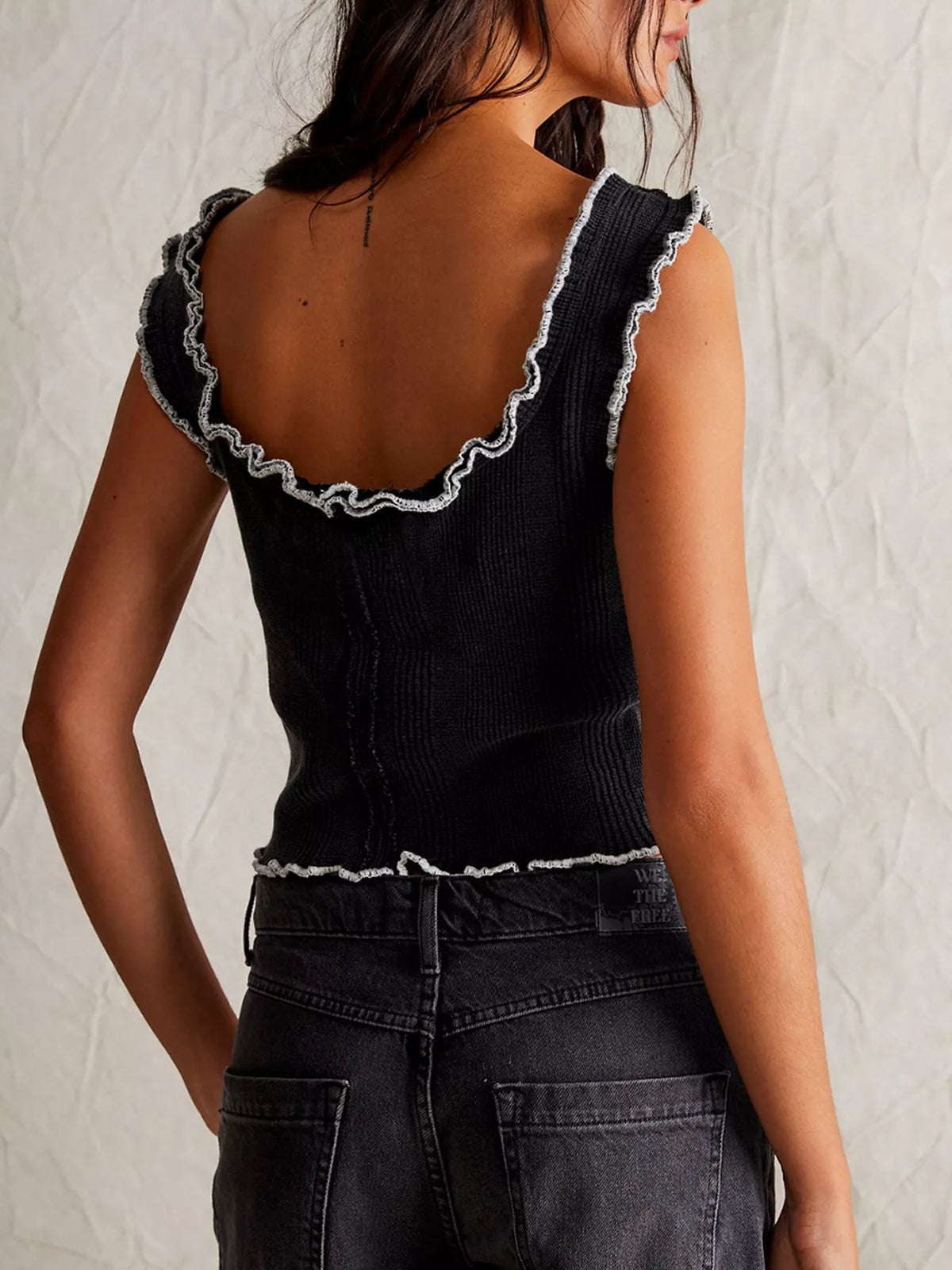 Cropped tank top hem and trim close up