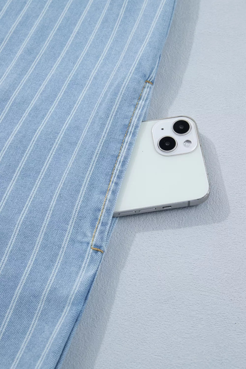 Light blue striped button back denim mini dress, front view
