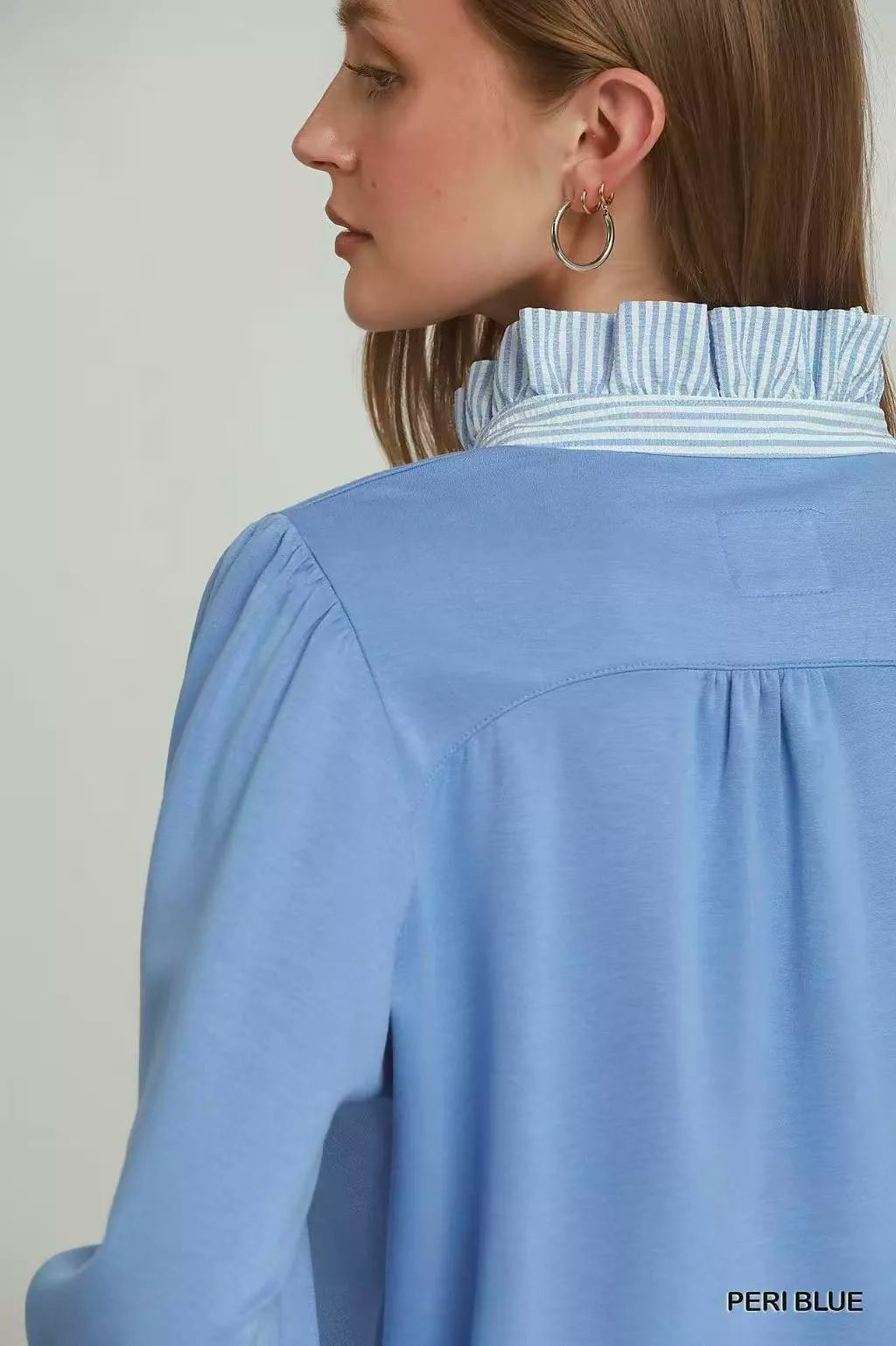 Umgee periwinkle blue striped ruffle neck top, styled on model