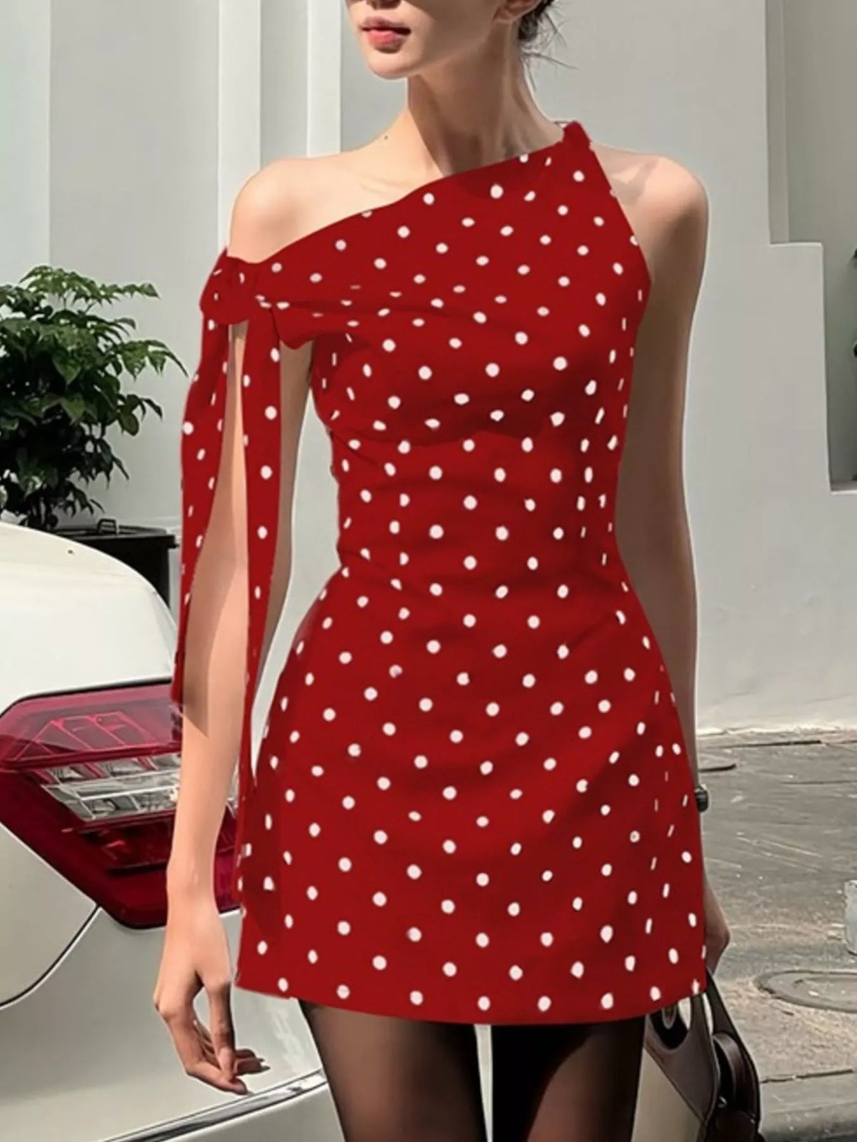 Stretchy polka dot dress shown close on the waist seam