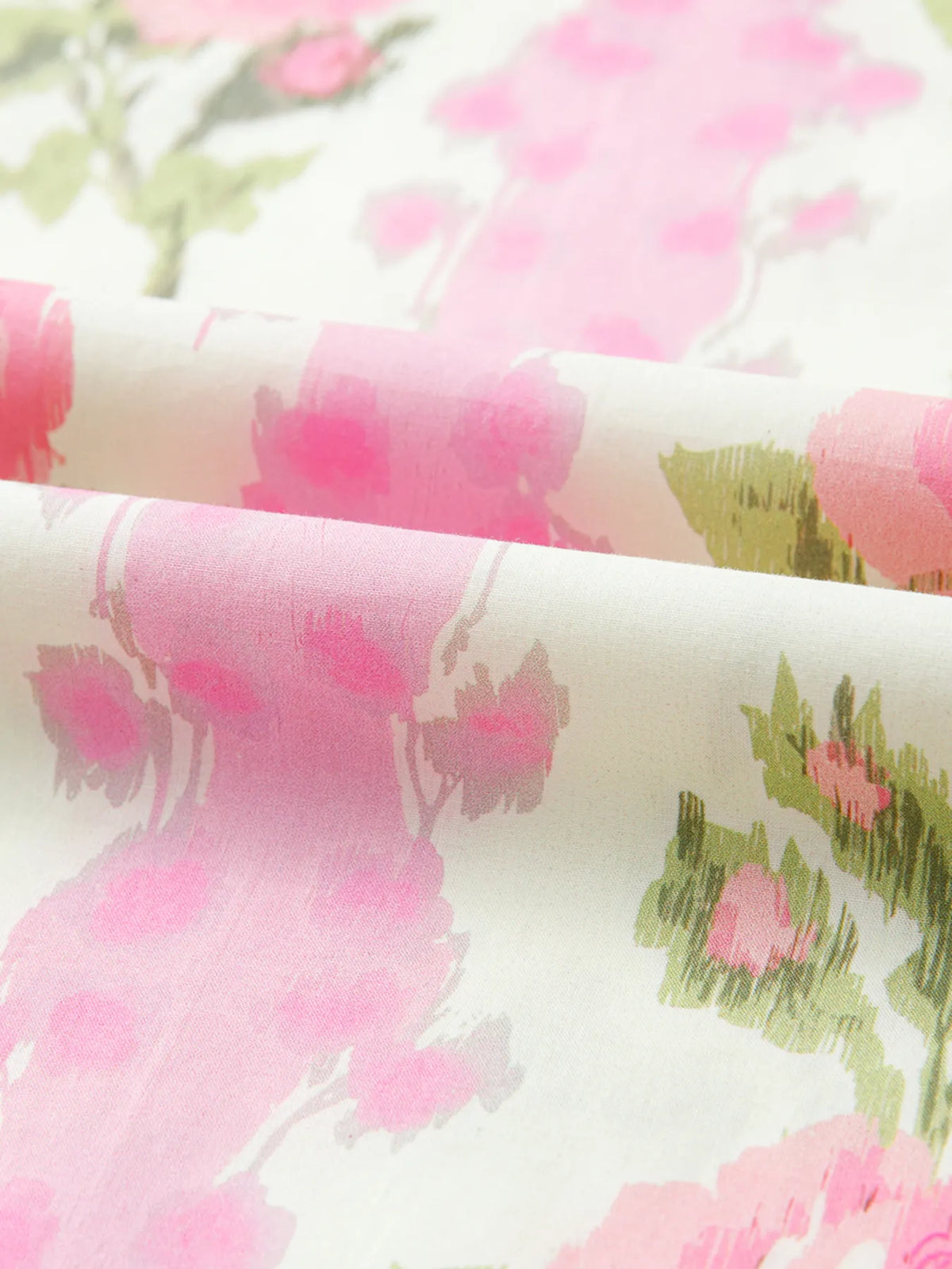 Blush pink floral blouse detail on model
