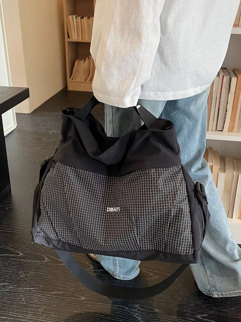 Black plaid nylon travel duffel bag front view