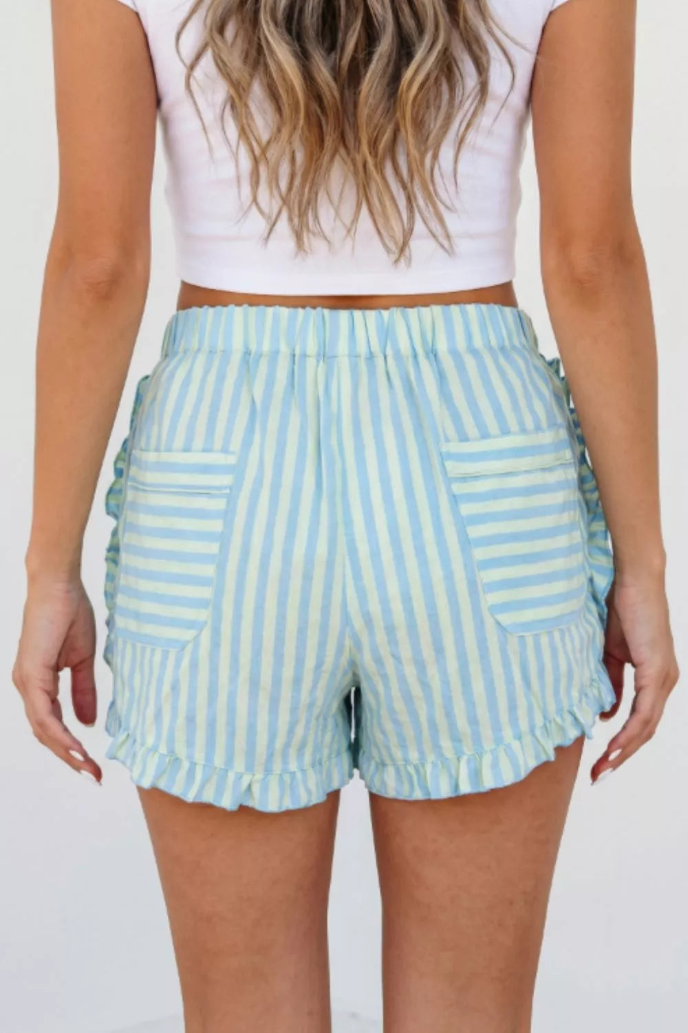 Turquoise striped shorts styled with a tank