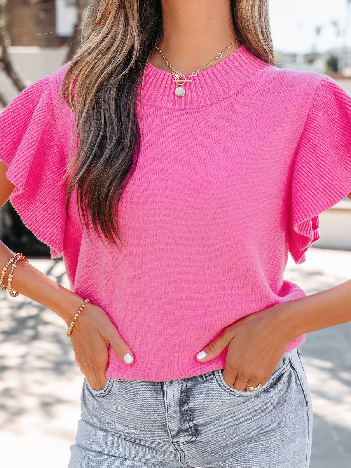 Bright pink knit sweater back view