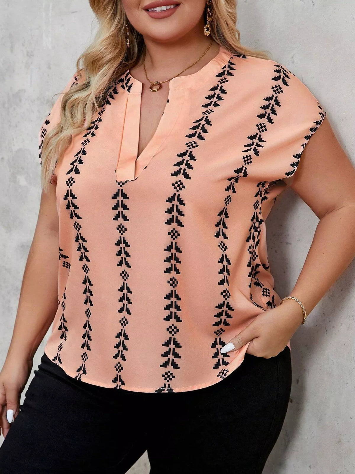 Coral blouse showing notched neckline detail