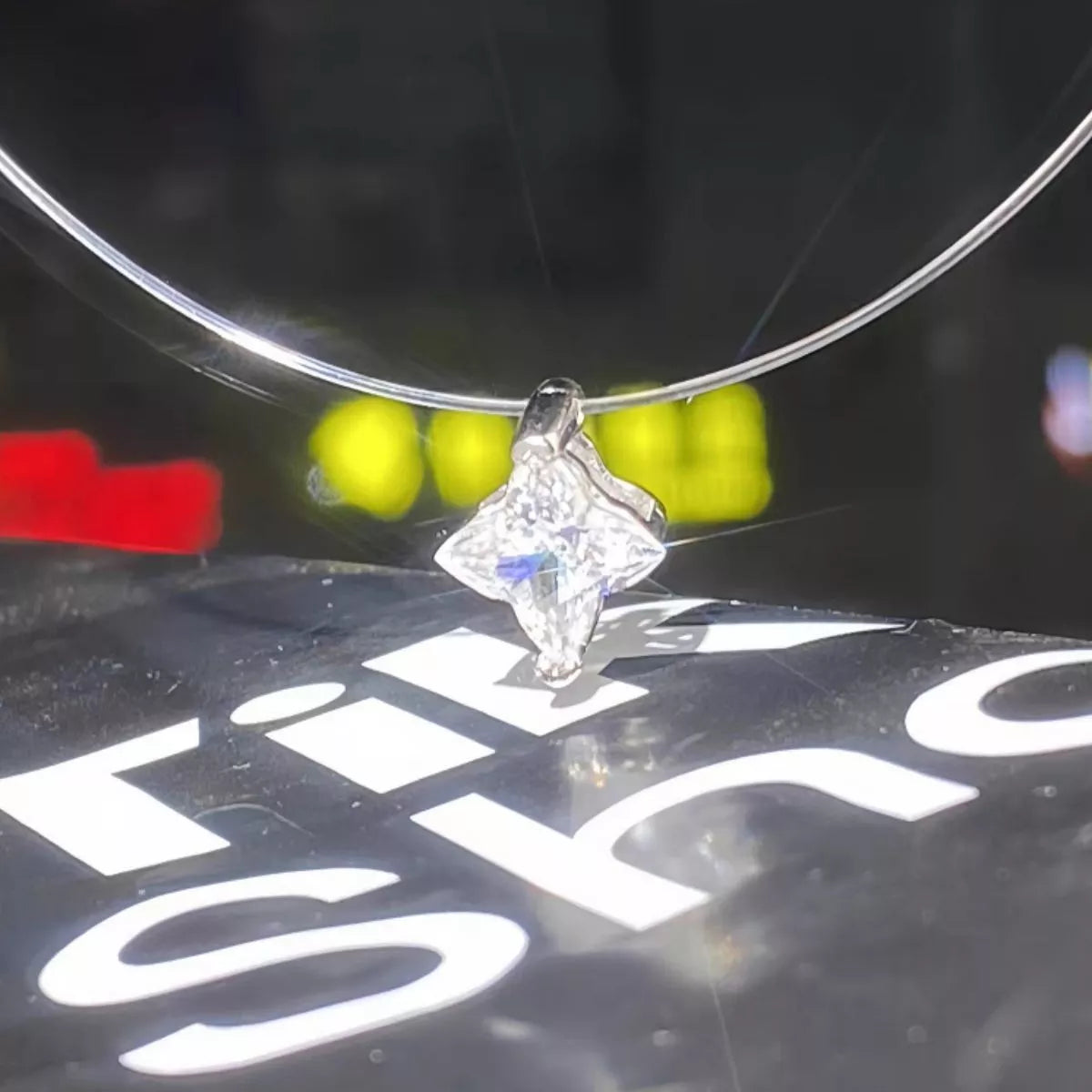 Star moissanite pendant shown on a model