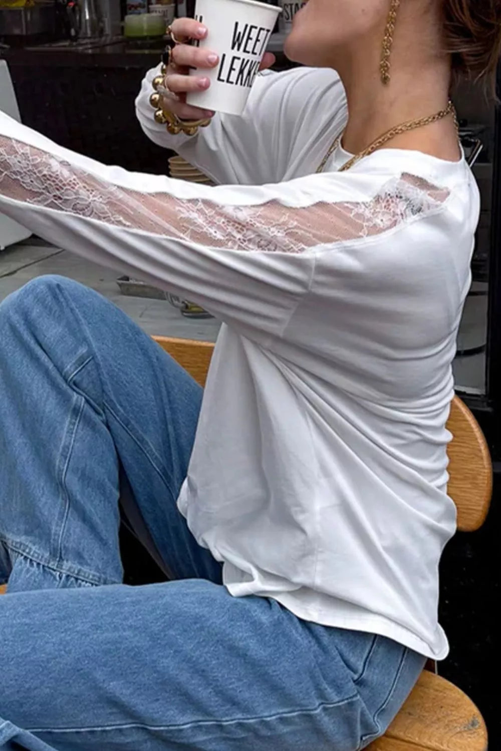 Round neckline detail on the white lace top
